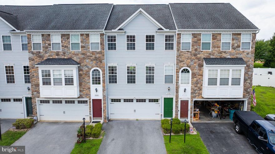 This beautifully updated 3-level townhome offers modern finishes, flexible living spaces, and a location that can’t be beat. Every floor has been thoughtfully renovated — with brand new luxury vinyl plank flooring on the entry and main levels, soft new carpet on the upper (bedroom) level, and fresh paint throughout.

The main floor welcomes you with a spacious, light-filled living room, a designated dining area, and a sleek kitchen featuring stainless steel appliances, an island with seating, and plenty of cabinet and counter space. Neutral paint tones and wide-plank LVP flooring create a warm, stylish vibe that flows throughout the level.

Upstairs, you’ll find three bedrooms including a generous primary suite with vaulted ceilings, a large walk-in closet, and a private bath with updated flooring, a soaking tub, dual vanities, and a walk-in shower. Two additional bedrooms share a second full bathroom, also with updated flooring and modern finishes. Upstairs you will also conveniently find your designated laundry room, with a new dryer and updated flooring. 

The entry-level offers a flexible rec room space with brand new LVP — perfect for a second living area, gym, home office, playroom, or homeschool setup. There’s a rough-in for a third full bathroom and access to the two-car garage for added convenience. The lower level also houses your utility room, with a new HVAC (2023) and tankless water heater.  

Out back, enjoy a touch of outdoor space that backs to trees for privacy and a little nature view. 

Tucked just minutes from Aldi, Walmart, restaurants, the MVA, and Rt 70 — and only 20 minutes from Frederick — this home checks all the boxes for comfort, style, and location.