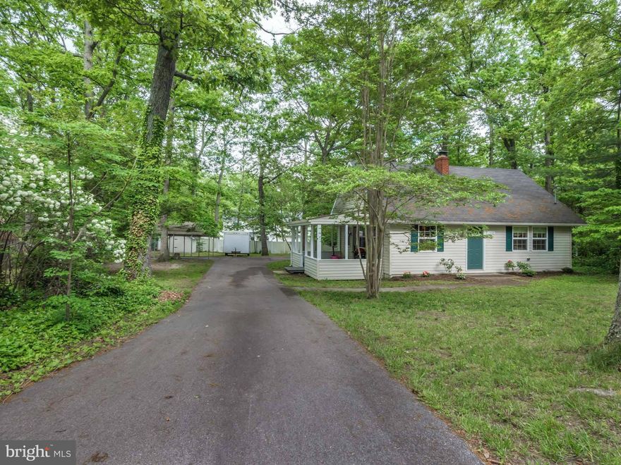 Very Unique and Inviting Cape Cod! Completely renovated in 2010! Open living area with cathedral ceilings and beautiful exposed wood beams. Attached 1 Car Carport can easily be converted to a garage. Very level lot w/ a large driveway and another detached 2 car carport that  is great for the car enthusiast. This home has the character, charm, and perfect yard that you have been looking for!