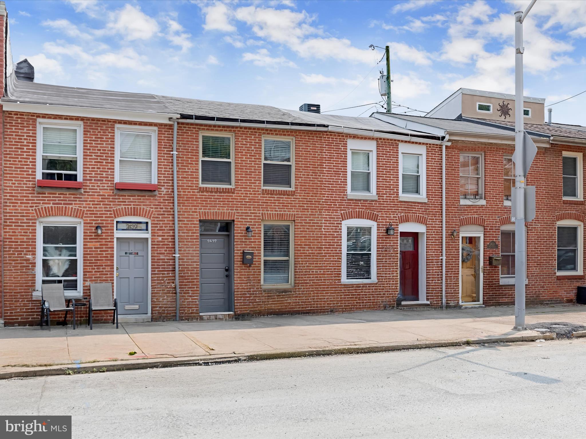 Welcome to this beautifully updated Colonial-style townhome in the vibrant Canton neighborhood of Baltimore City! Full of charm and modern touches, this home showcases an open-concept main level with a stunning exposed brick wall, rich hardwood floors, and a spacious dining area highlighted by sleek concrete flooring, perfect for entertaining. The gourmet kitchen is a chef’s dream, featuring Quartz countertops, stainless steel appliances, shaker-style soft-close cabinetry, and a decorative tile backsplash. A stylish powder room and access to a private fenced rear patio complete the main level. Upstairs, the sunlit primary suite offers a double-door closet, beautiful hardwood floors, and a contemporary en-suite bath, while the second bedroom impresses with vaulted ceilings, double closets, and hardwood flooring. Enjoy sweeping city views from the rooftop deck, ideal for relaxing and taking in the scenery. Just minutes from Patterson Park, the Inner Harbor, and the National Aquarium, with easy access to I-95, I-695, and I-83 for convenient commuting in any direction.