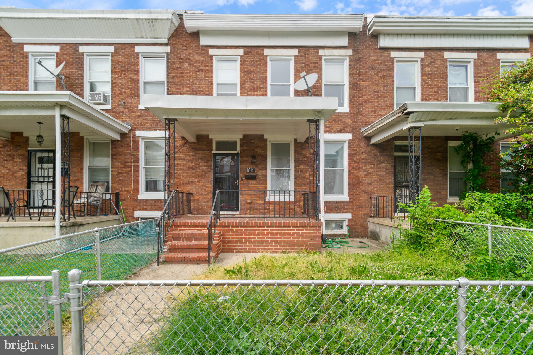 Classic style Baltimore Townhome offering 3BR/2BA on a quiet street. Make your way through the front gate to the covered front porch of your new home. Step inside to a fresh interior offering tons of natural light, gleaming flooring, and an open floor plan. The main floor offers a large living room and dining room, and a newly refreshed kitchen. The kitchen features plenty of cabinets, stainless steel appliances, a quartz countertop with a tiled backsplash, and an island with breakfast seating for three. On the second floor are two sizable secondary bedrooms, an oversized primary bedroom, and a full bath. The lower level offers additional living space featuring a full bath, laundry, a spacious family room, storage, and a walk-out to a fenced yard. From the dining room, or kitchen, step outside onto a spacious wood deck that overlooks a yard filled with so many possibilities. This home has so much to offer any new homeowner and is located in close proximity to shopping, restaurants, and commuter routes.