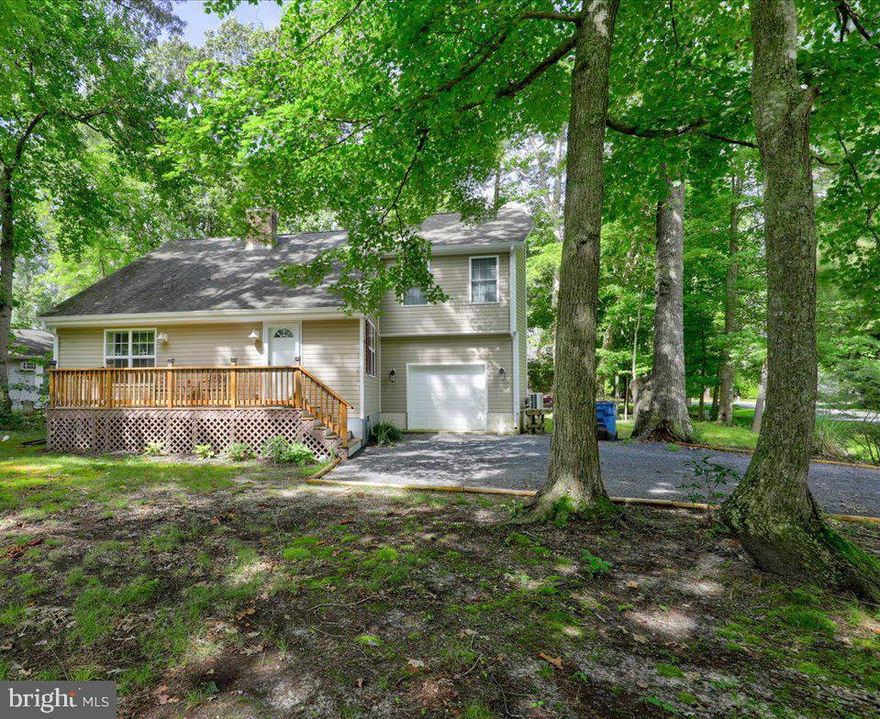 Big price adjustment on this 4 bedroom 3 bath cottage style house in South Gate Ocean Pines! Nicely renovated in 2016 to include roof, windows, flooring, kitchen, heat pump, baths, appliances, exterior Siding, decks & screen porch. Upon entering the front door, you'll love the great room with vaulted ceilings and a beautiful stained wood tongue and groove ceiling and cozy brick fireplace! Kitchen has stainless steel appliances, lots of counter space, bar area for casual dining and a pantry closet. Previous sellers stated 2017 as the year for the addition of the garage and the primary bedroom suite above. The newly added primary bedroom offers a barn door, walk-in closet, luxury vinyl plank flooring and a primary en-suite full bath. This home sits on a large corner lot offering .26 acres and  lots of space to enjoy the outdoors--front porch or rear screened in porch!