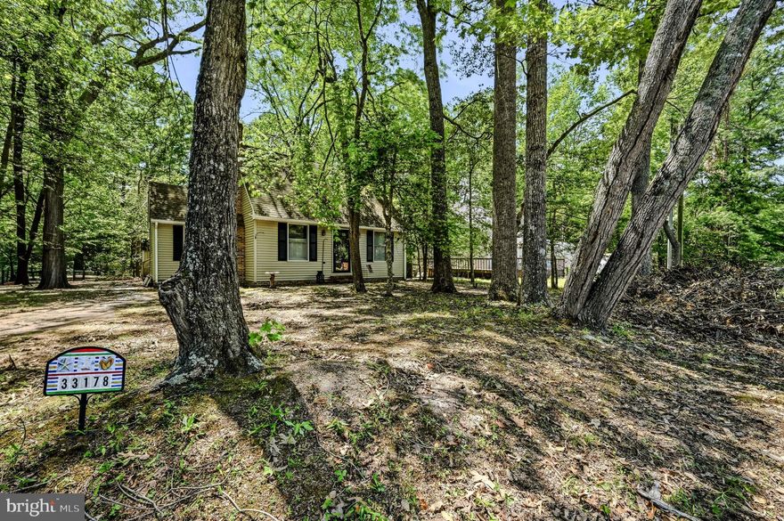 Welcome to 33178 Woodland Ct N, Lewes, DE 19958 — a charming coastal retreat nestled among mature trees in the desirable Angola By The Bay waterfront community.m with dock and clubhouse. This inviting 3-bedroom, 2-bath home offers comfort, character, and privacy just a short drive from the beaches, shopping, dining, and attractions of Lewes and Rehoboth. Updated include a new HVAC system in 2018 and roof in 2014. Inside, you’ll find a bright and functional layout featuring spacious living areas, large windows that bring in natural light, and a cozy atmosphere throughout. The kitchen offers ample cabinetry, generous counter space, and an adjoining dining area perfect for everyday living or entertaining guests. Comfortable bedrooms and well-maintained bathrooms provide practical living space with plenty of potential to make it your own. Step outside and enjoy the peaceful wooded setting from your deck(with outdoor shower), offering privacy and a relaxing outdoor environment ideal for morning coffee, gatherings, or simply unwinding after a day at the beach. Located in the sought-after Angola By The Bay community, residents enjoy access to amenities including a community pool, marina, clubhouse, tennis courts, and more. Whether you’re searching for a year-round residence, vacation getaway, or investment opportunity, this Lewes home offers the perfect blend of coastal living and everyday convenience. Schedule your private showing today!