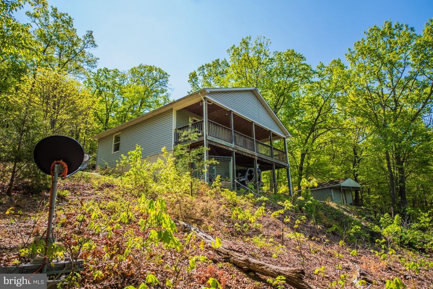 HIDEAWAY COTTAGE-Spectacular views from the full covered porch off the living room.  Over 5.5 acres that adjoins the GW National Forest.  Freshly painted and new carpet.  Open kitchen/dining/living area.  You will truly enjoy the peace and quiet, just 35 minutes from I-66. Lower level family room with cozy wood stove plus 3rd bedroom/sleeping area with built ins and half bath.