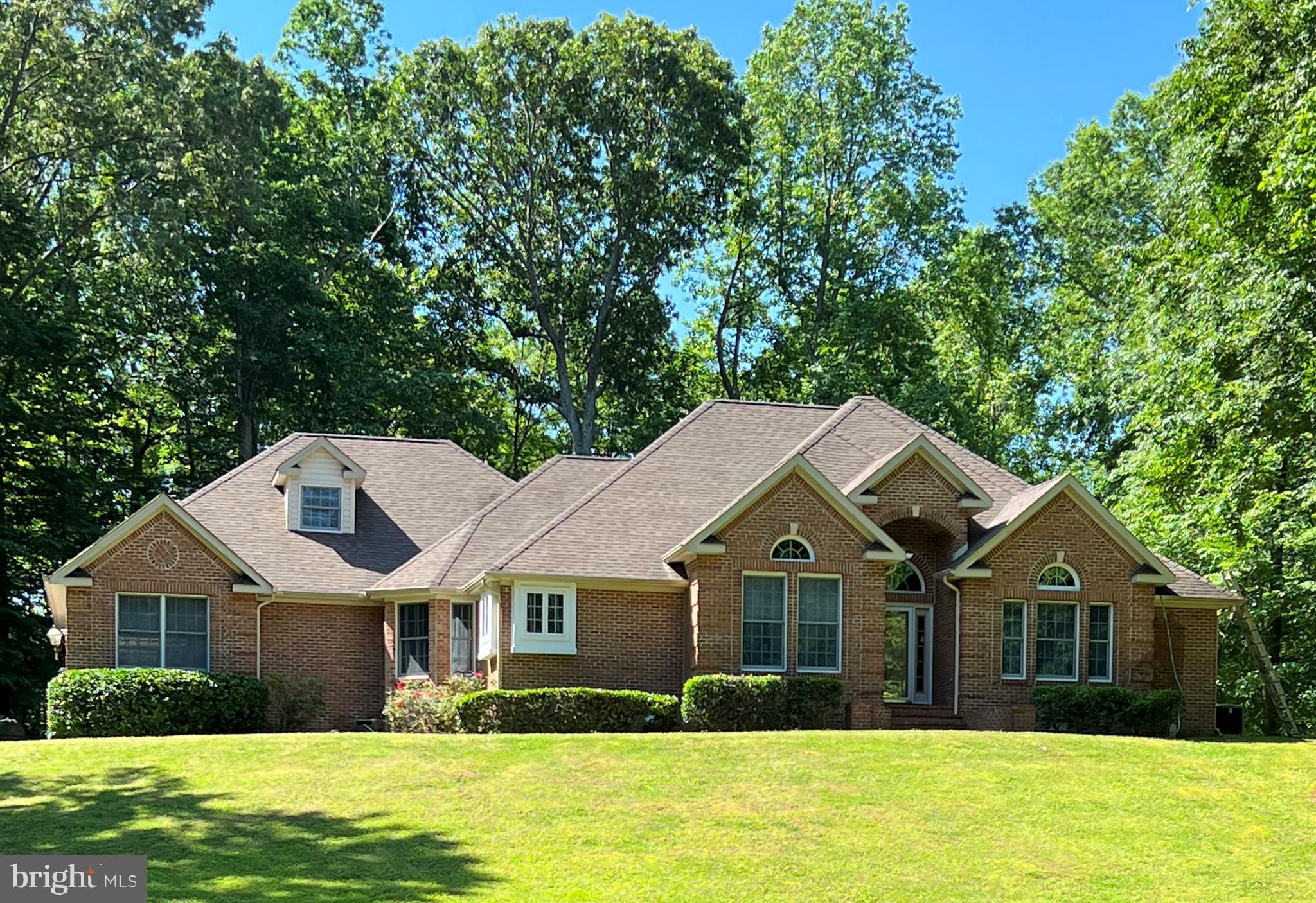 Privacy awaits! An extended paved driveway leads to this custom-designed, all brick rambler sited on nearly 7 1/2 acres providing the perfect retreat to enjoy peace and tranquility. 2,589 square feet of living space showcases this 5 bedroom, 3.5 bath home featuring a great room with a cozy brick fireplace and wet bar, a large formal dining room, hardwood flooring, a spacious kitchen with a double wall oven, granite countertops, a pantry and a breakfast nook and a conveniently located laundry room with a sink and cabinet storage. Upstairs you will find a bonus room with a full bath providing the perfect space for a 5th bedroom suite, office, playroom, etc. Retire to the owner's suite that features a two-sided gas fireplace, access to the exterior patios, a box tray ceiling, a walk-in cedar closet and a full bathroom with a separate shower, a corner soaking tub and double vanities. Down the hall you will find comfortably sized secondary bedrooms with built-in window seats, cedar closets and a large guest bath with a double vanity. Enjoy the outdoors on the covered porch that leads you to expansive paver patios and maintenance-free decking overlooking the beautiful, wooded hillside. Also, don't miss details such as a full house generator, a built-in paver firepit, a 3-car oversized garage and a heat pump with gas backup. All conveniently located in the quiet neighborhood of Chippingwood with easy access to Route 4.