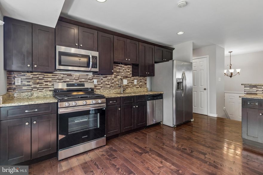 Tucked away in a Clinton cul-de-sac, this charming split foyer home offers a perfect blend of recent cosmetic refreshes and high-quality, established upgrades. The upper level welcomes you with a bright, open layout featuring brand-new neutral paint and rich hardwood floors that lead into a gourmet kitchen. Renovated in 2018, the kitchen is equipped with timeless dark shaker cabinetry, speckled granite countertops, and a full stainless steel appliance suite. The main level also hosts updated bathrooms, remodeled in 2018 with custom stone-patterned tile work, and modern vanities. Throughout the home, the transition between spaces is softened by brand-new, plush carpeting in the bedrooms.

The lower level of this split-foyer design maximizes functional space with a massive recreation room. This versatile area is illuminated by modern LED recessed lighting and anchored by a cozy fireplace with a custom-tiled surround—all part of the 2018 home updates. Whether you envision a high-energy game room or a quiet home office, this level provides the flexibility you need, along with convenient walk-out access to the outdoors. Outside, the property shines with a sprawling, level backyard fully enclosed by a sturdy wooden privacy fence. Backing to a serene, mature tree line for added seclusion, this home offers a move-in-ready sanctuary just minutes from Joint Base Andrews and major commuter routes.