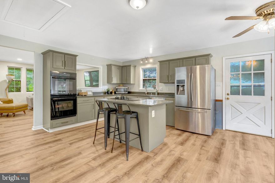 Welcome Home!
With almost one acre of land (includes 3 lots added together), discover endless possibilities in this beautifully updated property—perfect for a variety of living arrangements, including traditional, multi-generational, or partial rental setups. Nestled in a tranquil natural setting, yet just minutes from essential amenities, this home offers the best of both worlds.
As a member of the Lake Jackson Citizens Association (optional—please verify details), you’ll enjoy access to three boat ramps, a sandy beach, a picnic area, and abundant opportunities for wildlife watching.
Recent Updates & Features:
•     2025: Luxury vinyl plank flooring, new kitchen cabinets with gold hardware, updated light fixtures and switches, new walk-in closet in the primary suite, new carpet in select areas, added lower-level bedroom, asphalted driveway, new cooktop.
•     2022: New water heater.
•     2020: New well pump.
•     2016: Roof replacement.
Versatile Entry Options:
Arrive home to an extra-large two-car garage with workbenches and an additional freezer, or park in the spacious driveway. From here, you can enter through the lower level or step onto the welcoming front porch and enter at the main level.
Lower Level:
•     Large entrance/mudroom with direct garage access.
•     Expansive living and entertainment area with bar setup.
•     Separate bedroom and full bath—ideal for guests, in-laws, or rental income potential.
Main Level:
•     Bright and airy family room adjacent to the kitchen.
•     New cabinets, gold hardware, kitchen island seating, and cozy breakfast nook next to the dining area—perfect for entertaining.
•     Two generously sized bedrooms and a full bath on one side of wide hallway.
•     Primary Suite on the opposite side with sitting area, custom-built walk-in closet with window, and a spa-inspired shower featuring a two-head walk-in shower.
Two attic spaces that can be used for storage.
This home offers space, flexibility, and thoughtful upgrades—making it a must-see. Schedule your visit today. This is a Relocation !