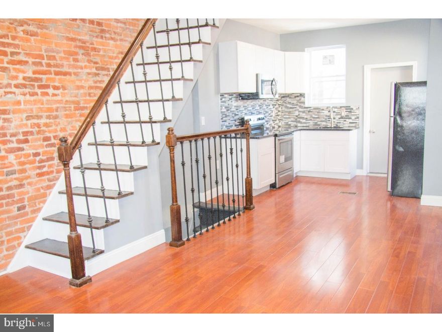 Welcome home to this newly-rehabbed 2 bedroom, 1.5 bath home on a quiet street in highly-desirable Carroll Park. Main level includes an open floor plan with spacious living/dining areas, a gorgeous exposed brick wall, custom iron railing, beautiful hardwood floors and recessed lighting throughout. The modern kitchen includes white shaker-style cabinetry, gorgeous granite countertops, tiled backsplash and a stainless steel appliance package including refrigerator, electric range and built-in microwave. Exit the kitchen to the cozy backyard, perfect for relaxing or summertime grilling. The second level includes two spacious, bedrooms with new hardwood flooring, ample closet space & recessed lighting and a fully updated newly tiled, hall bathroom with new tub, modern vanity and new wood tile flooring. The fully carpeted finished basement includes a powder room with new vanity/toilet and laundry room with laundry hookups. The finished basement is great for your office, man/woman cave and/or room for storage. New HVAC system, new hot water heater, new windows, recessed lighting, brand new appliances, etc. offers maintenance-free living for quite some time. Centrally located, minutes from City Line Avenue, 76, shopping, schools, restaurants and a few footsteps from public transportation. Just pack your bags & move right in! Schedule your showing today! You will not be disappointed!