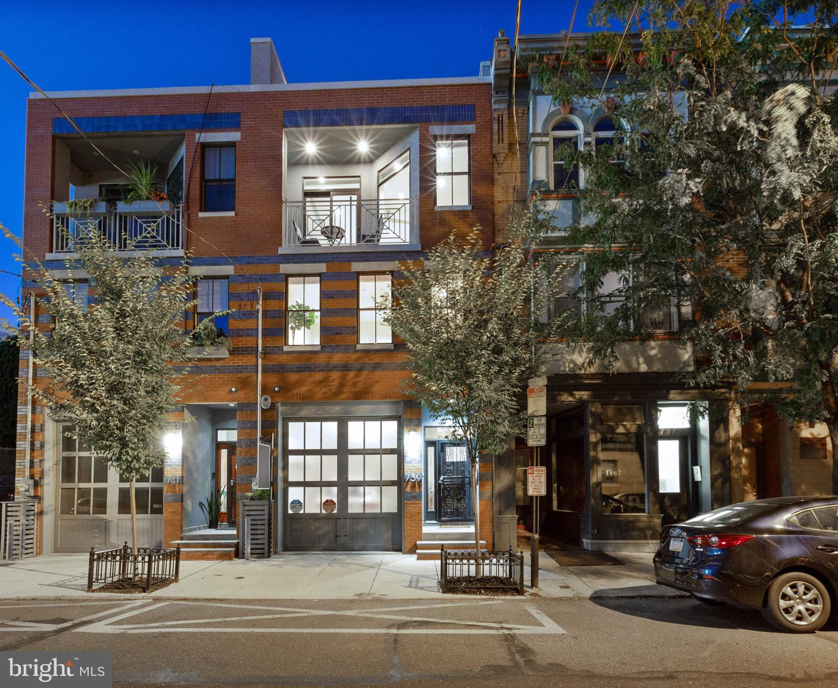 Welcome home to this beautiful 4 bed, 4 bath 3,100+ sq ft, 3 story, red brick, rowhome on a quiet tree-lined street in Bella Vista. This near brand new construction (2016) contemporary residence in the Meredith Elementary School catchment boasts over seven years left on tax abatement, private front-loading garage, smart home technology, multiple outdoor spaces, and an upgraded roof deck with breathtaking city views. The open first floor features a gourmet kitchen with marble countertops, top of the line kitchen appliances (Sub-zero, Wolf, Asko), Sub-zero wine refrigerator, custom cabinetry with under cabinet lighting, and a large island with breakfast bar and gorgeous waterfall countertop. The bright living room features a glass fireplace framed in custom tile, recessed lighting, and maple hardwood floors that run throughout the first three levels of the home. Upstairs, the second floor has two spacious bedrooms with spacious closets, large windows, ceiling fans, and ensuite bathrooms with upgraded finishes. A laundry room with full size front loading washer and dryer completes the second floor. The luxurious master suite can be found on the third floor, and features an outdoor balcony, large his and hers walk-in closets, custom double-bowl vanity with quartz countertop, radiant heated floors, rainfall shower head, frameless glass shower enclosure, and a light-filled office/den. Downstairs in the lower level, find a media/great room with tile flooring, ample closet space, and a wet bar with under counter refrigerator that could double as the perfect nanny or in-law suite. A full bathroom with a standalone shower and spacious storage area that could be perfect for a gym finishes off the lower level. This home certainly doesn t lack in outdoor space with a back patio perfect for grilling and an epic roof deck with electric and water hook up, making it great for entertaining. A wireless sound system runs throughout the home and the roof deck. Conveniently located near SEPTA and many of the city s best parks, this home is just moments away from Center City and the best shopping, dining, and cultural sights. You are also just a few blocks from Whole Foods, the Italian Market and all that Bella Vista, Queen Village and Midtown Village have to offer. You do not want to miss out on this great home! Schedule an appointment to see it today.