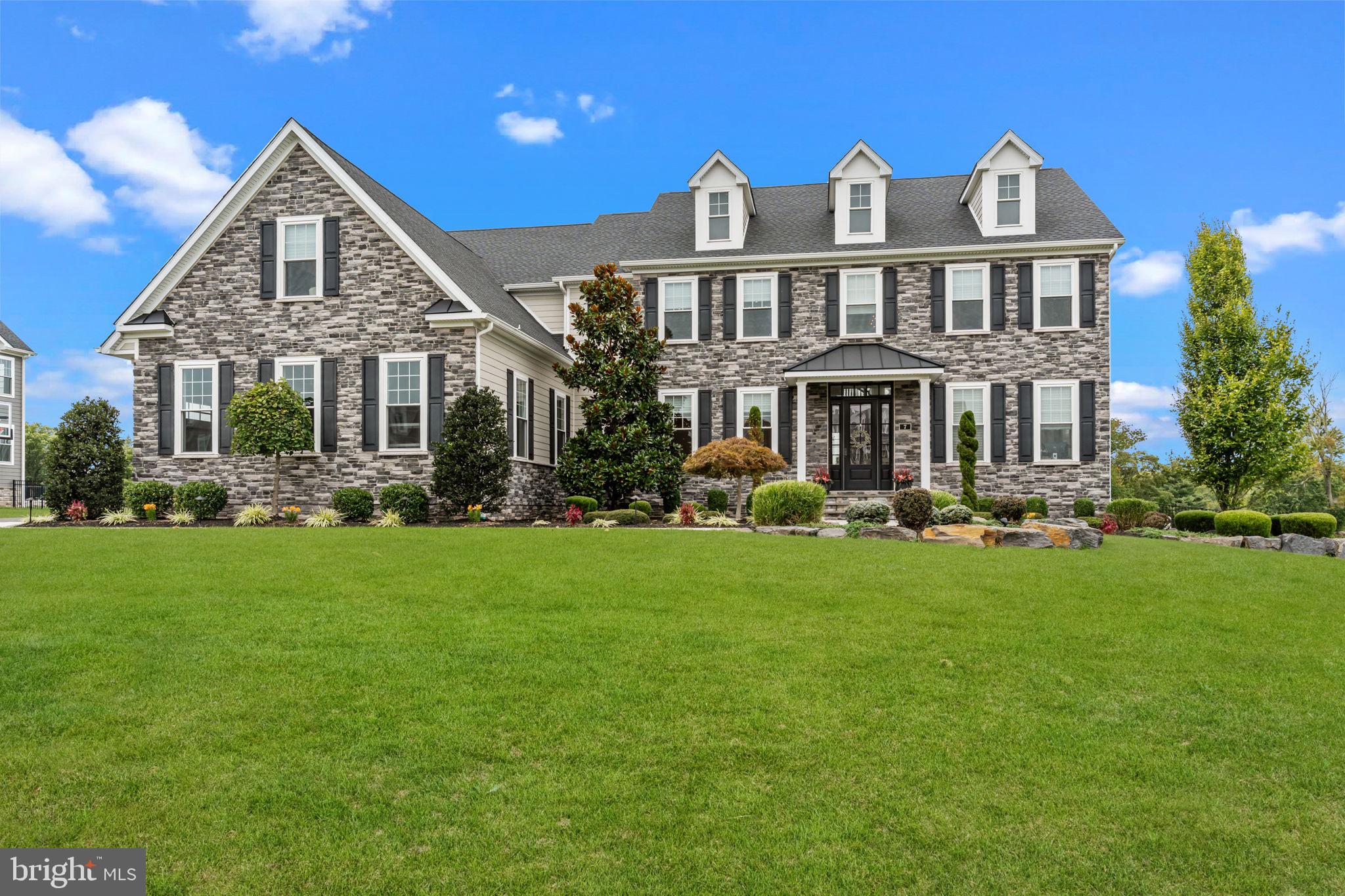 Welcome to Jericho Estates – Luxury Living in Newtown Township, Bucks County
Located in prestigious Newtown Township and within the top-ranked Council Rock North School District, Jericho Estates is an exclusive community of just nine custom homes, nestled among more than 21 acres of permanently preserved open space—protected by deed restriction from future subdivision for long-term privacy and peace.
The featured Ashton model showcases a thoughtfully designed, expansive open-concept layout with 10-foot ceilings on the first floor and a dramatic two-story family room featuring a coffered ceiling and a rear wall of windows that floods the home with natural light. The gourmet kitchen includes a large center island and sun-drenched breakfast room, flowing seamlessly into the main living space.
Entertaining is effortless with a butler’s pantry and formal dining room, while the private study or guest suite with a full bathroom, spacious mudroom, and convenient powder room offer functionality and comfort on the first floor.
Upstairs, enjoy 9-foot ceilings and retreat to the luxurious owner’s suite, complete with a cozy Inglenook sitting area, two walk-in closets, a private dressing room, and a spa-like bath with a freestanding soaking tub and an oversized shower. Three additional bedrooms, two full bathrooms, and a well-equipped laundry room complete the second floor.
The fully finished walk-up basement, with impressive 10-foot ceilings, expands your living space even further—featuring a large game room, oversized bar, full bathroom, and an additional guest bedroom. For added peace of mind, the home is equipped with a full backup generator along with 11 zone landscape irrigation system.