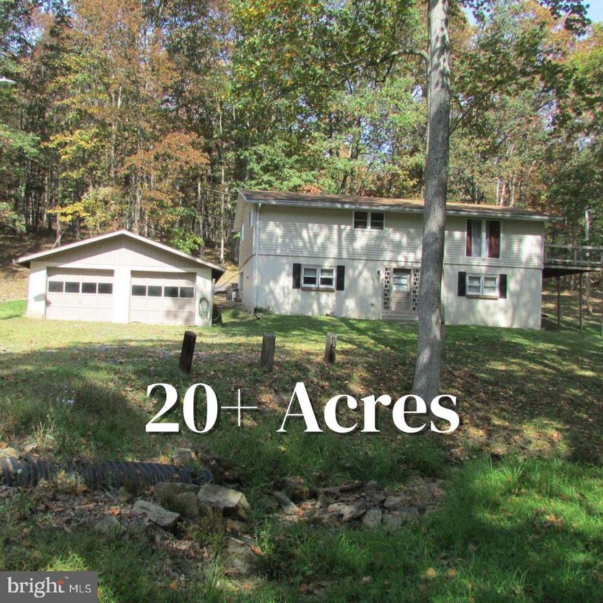 20 plus wooded acres provides you with the perfect mix of privacy, comfort and adventure. Welcome to 14742 Happy Hills Rd, a beautifully updated 4 bed, 2 bath bi level home tucked away with its very own stream! Whether you’re searching for a weekend getaway, a year-round residence, or a nature lover’s dream, this Huntingdon County gem checks every box.

Step inside to an inviting open-concept main level with a bright living room, spacious dining area, and a modern eat in kitchen perfect for entertaining or cozy nights in. Enjoy peace of mind with recent upgrades including a new septic system (2022), central A/C, and updated appliances. Downstairs, the fully finished lower level features a large family room, a private fourth bedroom, and walkout access to your outdoor oasis.

Love the outdoors?  You’ll adore the sunroom, expansive deck, and the sound of the stream in your backyard. Plus, the detached 2 car garage and 44’x26’ outbuilding give you tons of space for your camper, boat, workshop, or gear. Only 25 minutes from Lake Raystown and close to State Game Lands, this property is ideal for hunting, hiking, and getting away from it all.

If you're ready to enjoy privacy, peaceful views, and year round access to outdoor fun. Happy Hills is calling!