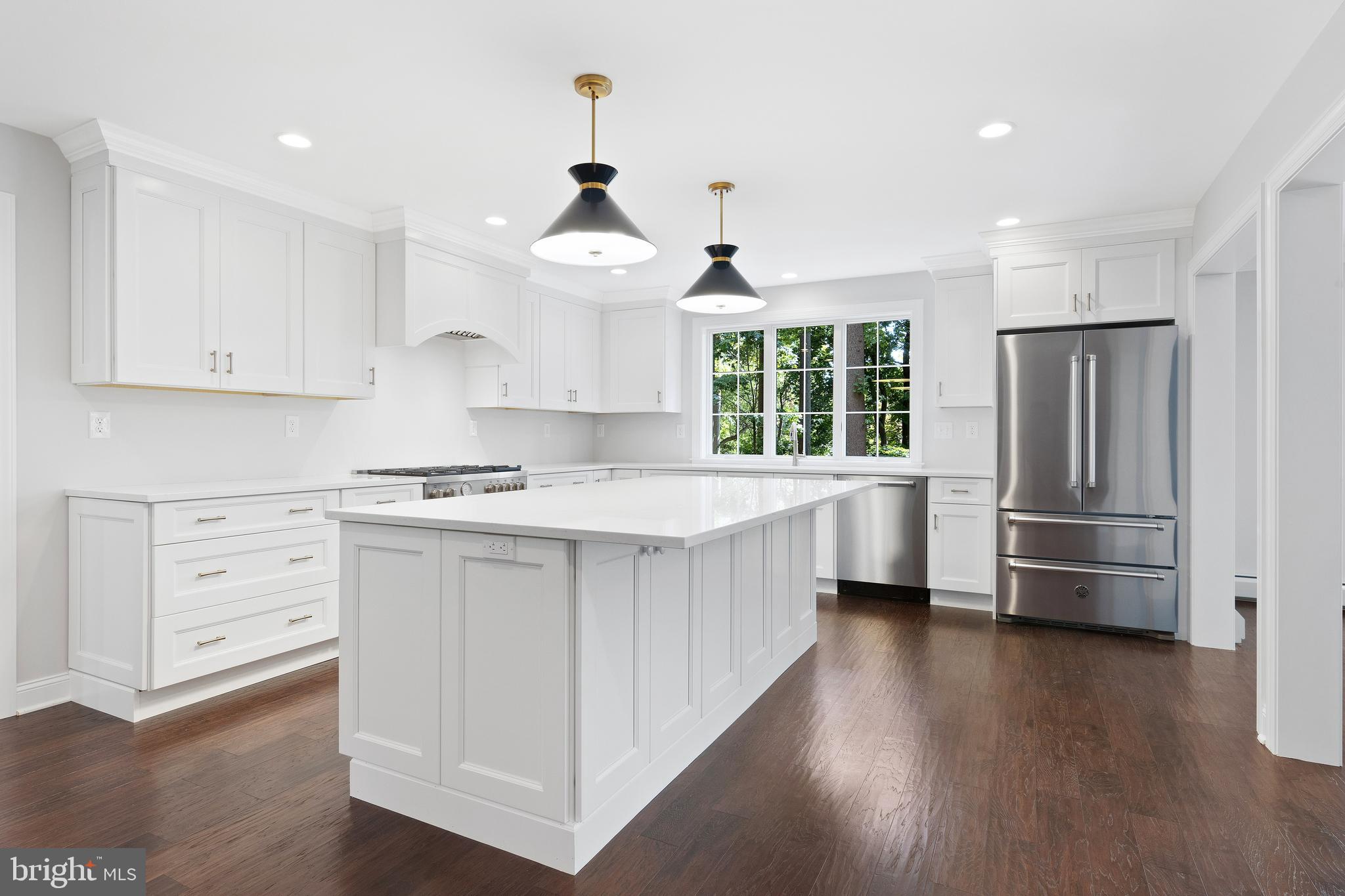 Move right into this meticulously renovated 4 BD, 4/2 BA two-story brick colonial at the end of a quiet cul-de-sac in Radnor Township. From the brand new roof to the remodeled basement, almost every inch of this beautiful home has been renovated within the past year! Walls were removed and the main floor was expanded to create a spacious, gourmet kitchen with a huge island that opens to a bright Family Room with gas fireplace. Doorways were also widened between the Center Entrance Hall, Living Room, and Dining Room to enhance flow between rooms. Fresh neutral décor and gleaming new wood floors were installed throughout the entire first floor. Kitchen & Bathrooms have white quartz counters. A Mudroom with cubbies, and a new Half BA are located in the rear Hall, which opens to the driveway and also to the 2-car side-entry Garage. Downstairs is a renovated Recreation Room with new walls and flooring, new egress window, recessed lighting, new 2nd Half Bath, and a Laundry Room. Upstairs, the Master BD suite features two closets with custom organizers and a gleaming, large new BA with frameless glass shower, private toilet room, and double vanities. 3 more bedrooms, 3 more full baths, and a large 2nd Laundry Room complete the 2nd floor. Bonus Room with closet adj. to Master BD is ideal for a convenient nursery or home office. There is abundant closet space (with professional closet organizers) throughout this great home. A new flagstone patio overlooks the separately fenced, sparkling pool and level yard which offers ample room for recreation. Mature trees and perimeter plantings provide privacy. Great location, just 5 minutes to Radnor train station, and close to schools, shops, and restaurants in the charming village of Wayne. Convenient to the Blue Route, Center City, Airport, universities, medical, and corporate centers. Street was just re-paved. Low taxes for a home with this many updates and space.