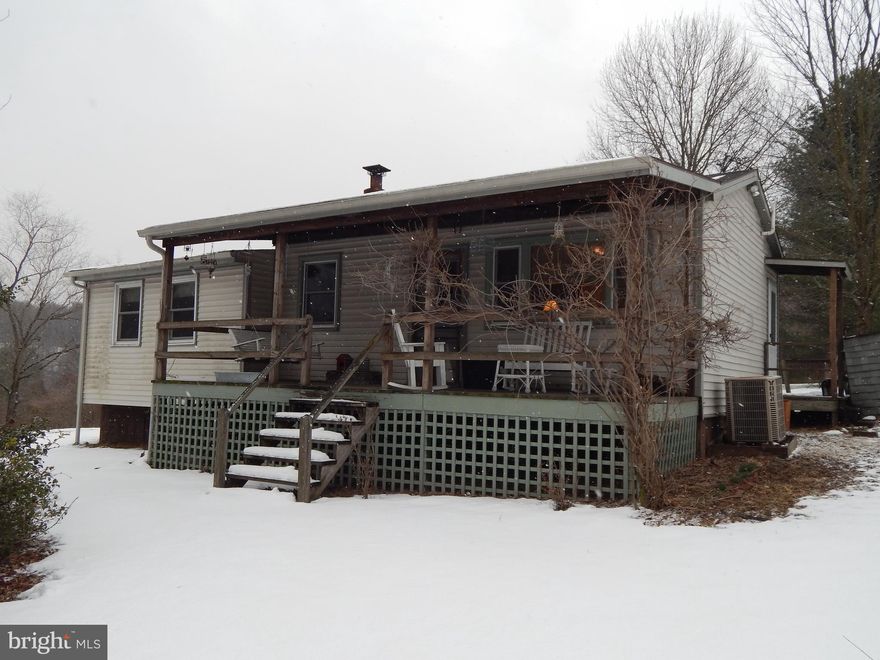 Getaway cabin with community access to the Sleepy Creek.  Cabin features open LR/Kitchen/Dining area with wood stove. Additional 2 rooms features 1 BR and room that is used as a living room but could be used as a 2nd bedroom.  Front Porch, back deck and 2 storage sheds