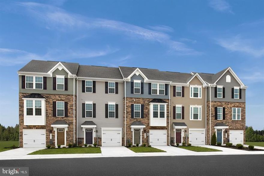 MOVE-IN READY!  *** ASK ABOUT OUR SPECIAL $20,000 FLEX CASH  INCENTIVE FOR A LIMITED TIME ONLY! 
This end unit is located in a prime location. The convenience of townhome living meets the amenities of a single family home in Ryan's Mozart. The sculptural staircase sets the tone of elegant simplicity and functionality that continues through the rest of the home. On the main living level, an enormous Kitchen with island and granite countertops opens onto a bright and airy Living Room.  This open concept area is perfect for entertaining and featuring either a handy coat closet or a conveniently placed powder room.  
 Off the kitchen is a 18' x 10' deck for outdoor living space. Upstairs are two spacious secondary bedrooms with ample closet space, a hall bath. A generous Primary Bedroom that features a tray ceiling and a huge walk-in closet. For a truly spa-like experience, the separate Primary Bath features a dual vanity and shower with dual shower heads. The lower level features a finished Recreation Room and a 1 Car Garage.