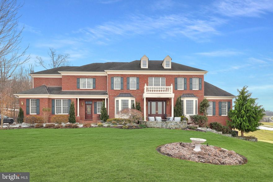 Exquisite Estate Living on 3+ Private Acres in Waterford! Welcome to an exceptional luxury residence nestled on a peaceful cul-de-sac in the highly desirable Waterford area, offering over 7,600 square feet of beautifully appointed living space across three finished levels. 
Situated on approximately 3.3 private acres, this elegant brick estate seamlessly blends timeless architectural design with extensive high-end upgrades, thoughtful custom expansions, and resort-style outdoor living.
The heart of the home is the spectacular chef’s kitchen featuring premium GE Appliances Monogram appliances, upgraded granite countertops, an oversized center island in the Palladian kitchen addition, wine cooler, and a second pantry — all opening to the dramatic two-story family room expanded by six feet with open beamed ceiling, curved balcony with iron balusters, shadow box molding, and a stunning wood-burning fireplace with upgraded mantel and surround. Elegant formal living and dining rooms showcase tray ceilings, bay windows, chair rail shadow box molding, and designer smoked bronze mirror accents, while the private study offers a full wall of custom built-in cabinetry. 
A bright conservatory with additional built-ins provides flexible living or entertaining space. Upstairs, the luxurious primary suite features a coffered ceiling, spa-inspired bath with ceramic wrapped columns, floor-to-ceiling mirrors, clean glass shower, soaking tub with coffered ceiling detail, and generous walk-in closet. Secondary bedrooms are spacious and well appointed, while the upgraded laundry room includes extensive shelving and mesh drawer organization. 
The fully finished walk-out lower level is designed for entertaining and relaxation with a raised stone wood-burning fireplace, full stone accent wall, built-in cabinetry, window seating, custom bar, and guest accommodations. 
Outdoor living is equally impressive with a custom deck, expansive rear patio, front patio, professional hardscaping, landscape lighting, and beautifully maintained grounds. The home also features premium ProVia front entry doors, a whole-house Generac Power Systems generator, three HVAC systems (replaced 2021), upgraded flooring throughout, and a 3-car side-load garage. 
This extraordinary property offers privacy, sophistication, and convenience — a rare opportunity to enjoy refined estate living in one of Loudoun County’s most picturesque settings.