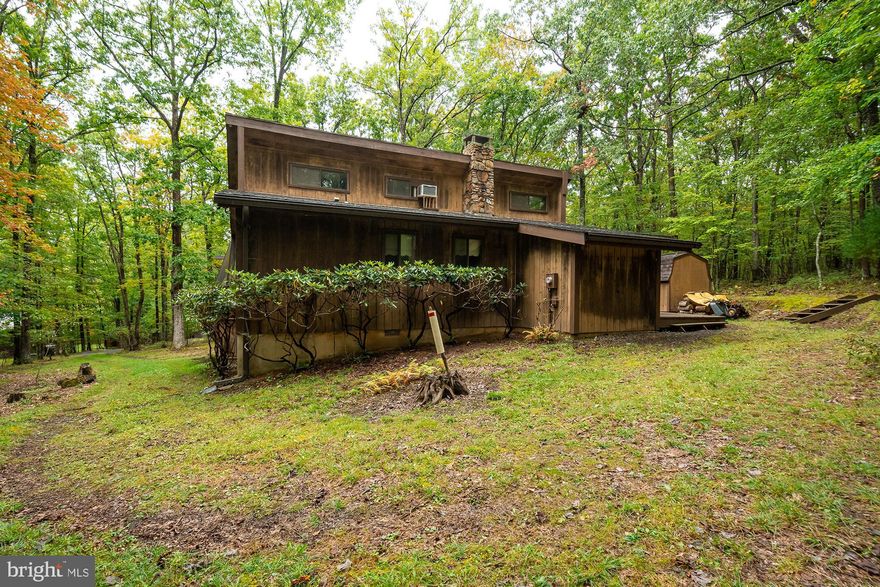 Lake access cottage located in Back Bay Colony. This home offers three bedrooms, a large stone wood burning fireplace and cathedral ceilings. Nice lake access with a dedicated beach area and a dock slip. The outside space boasts a large deck, screened covered porch that is equipped with outdoor Bose speakers, custom built picnic table, shed/utility building, basketball backboard, badminton, volleyball court and horse shoe pits. The location is very close to the Yacht Club. The possibilities  are endless with this property, call today for a preview!