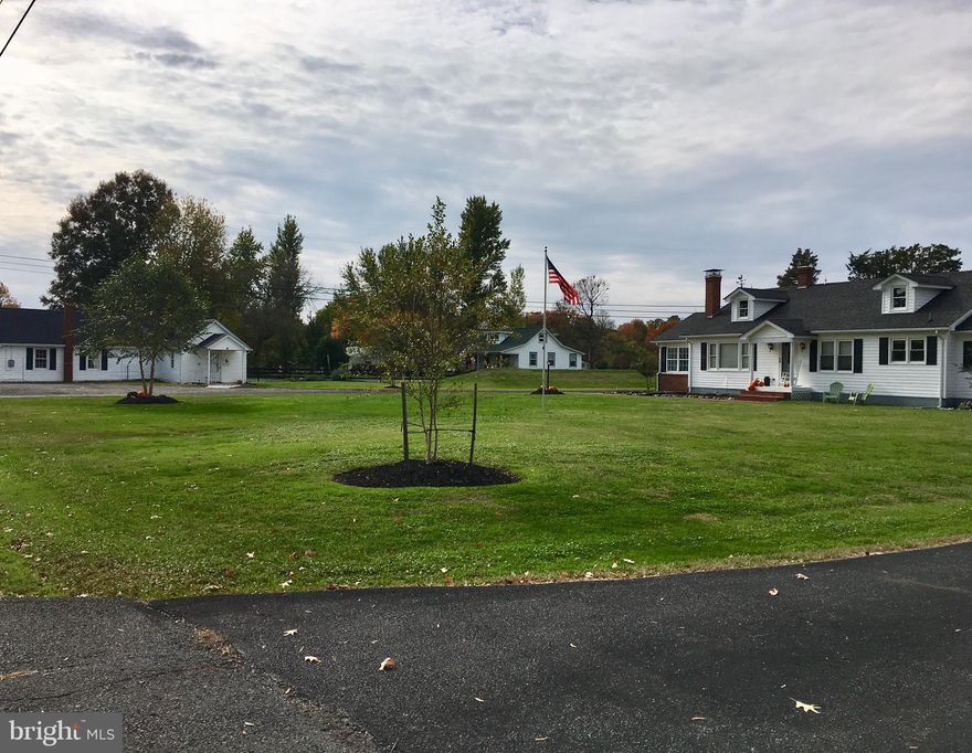 Unique property w/main house + out building  used as gym/rec room w/1/2 BA. Well maintained & improved. Beautiful wood floors, FP,wood stove, huge laundry/utility, bright sunroom. New septic& HVAC, newer roof on cottage & main house, crawl has been conditioned, generator-ready.  Deep front yard + fully fenced lge back yard.  Det. garage, home warranty. Main house 2BR/1BA  1650sf,