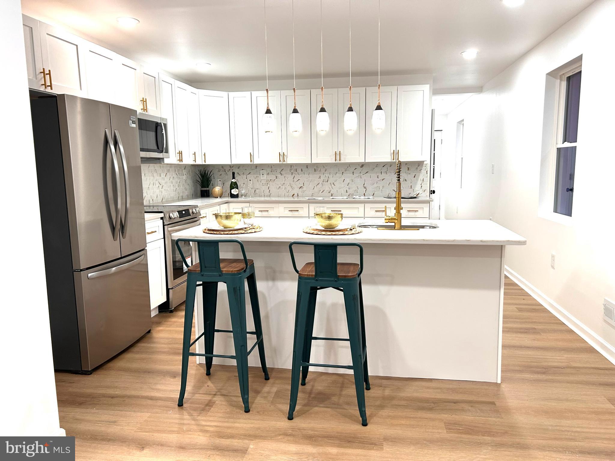 Welcome to 580 Bath Street—an immaculate 4-bedroom, 2.5-bathroom home with a fully finished basement, located in the heart of Historic Bristol Borough where city living and suburban charm beautifully intersect. Completely rebuilt from the ground up, this luxurious home is move-in ready and designed with both style and functionality in mind.
As you step inside, you're welcomed by an open-concept floor plan with recessed lighting and modern finishes throughout. The show-stopping white and gold kitchen features quartz countertops, a center island with striking gold pendant lights, and contemporary fixtures that make this space both elegant and inviting. On the main level, a versatile room offers the flexibility to be used as a home office or additional bedroom, perfect for today’s lifestyle.
Upstairs on the second floor, you’ll find two spacious bedrooms with ceiling fans, a full bathroom, and a conveniently located laundry area. This level also opens up to a large second-floor deck that overlooks the backyard, providing an ideal spot for relaxing or entertaining. The third floor is home to the stunning grand suite, complete with his-and-hers closets, recessed lighting, a luxurious en-suite bathroom, and access to a private deck with scenic views of Bristol Borough.
The fully finished basement offers endless possibilities for use as additional living space, a home theater, or entertainment zone. Outside, enjoy the low-maintenance exterior and a prime walkable location just minutes from the Delaware River, Mill Street’s vibrant restaurants and shops, the marina, and the Bristol Borough Regional Rail Station, offering easy commutes to Philadelphia, Trenton, and NYC via the Trenton line.
This home is elegant, considered new construction, and low-maintenance. Home Warranty
included, for added peace of mind. Schedule Your Showing