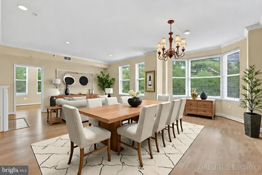 The Stratford House! Luxury Living at it's Best! Gorgeous Contemporary with Open & Flowing Floor Plan. Enjoy the spectacular view of treetops, swimming pool, and Reston Town Center. One block from Reston Town Center and 3 blocks from the Metro Station, Reston. Two Bedrooms and 2 Full Baths, Living Room with a Gas Fireplace, Dining Room, DEN, and Kitchen with Breakfast Area. New AC and Thermostat 2025, Furnace 2024 and newer Washer & Dryer.  Many upgrades include upgraded Kitchen & Bathrooms, and Closet Systems. 
TWO Nice Underground Garage Parking Spaces & Extra Storage with and plenty of outdoor parking for guests. The well maintained building features an ELEVATOR from the basement garage. Enjoy your summer days at the community POOL or workout in the FITNESS CENTER or enjoy nature on the W&OD trail that is right next to the complex. Then treat yourself to dinner at one of the many wonderful restaurants that the Reston Town Center has to offer! Close to everything including public library, grocery stores and pharmacies. Need to Commute? No worries! The Toll Rd. is up the street or take the METRO to work or just to visit DC - the new station is adjacent to the Town Center. Check out the 3D Matterport!