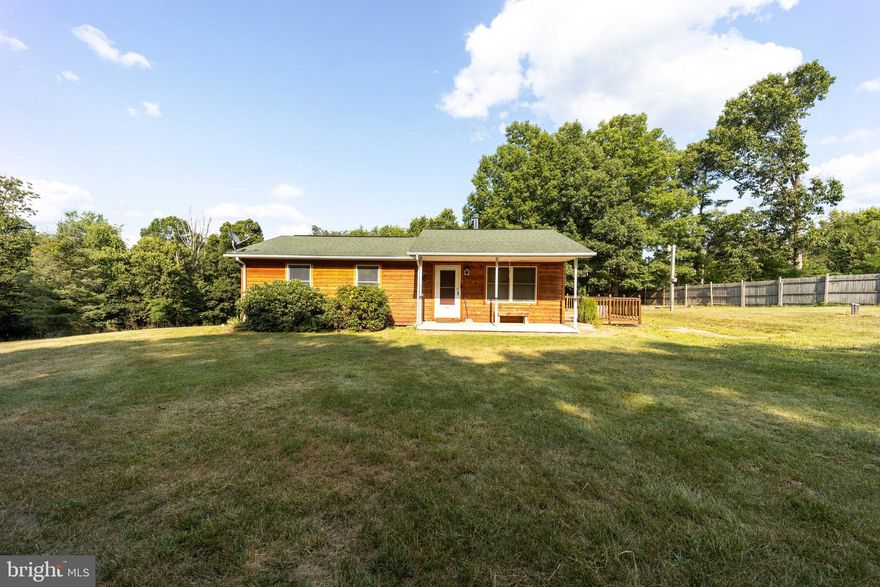 Newer roof, heat pump, wood siding and deck.  Private yard with a seasonal run at property boundary.  Cute ranch with wood stove in living room.  Interior photos coming soon. Metal storage building conveys.