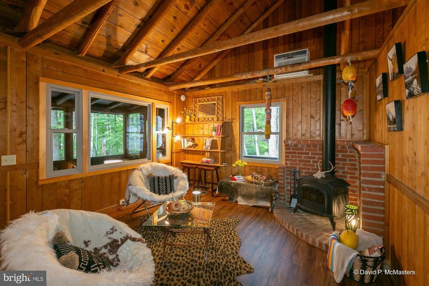 Almost Heaven West Virginia ON the Blue Ridge Mountain and minutes from the Shenandoah River! 
 This is an amazing opportunity for your dream mountain escape tucked away on a quiet street in peaceful Shannondale with the ability to have access to beautiful private lake.  

This cabin is one of the few perfectly preserved original log cabins constructed in an earlier era.  Two bedrooms, one full bath and the cutest loft overlooking the great room.  Beautiful solid wood wall cladding, round log rafters and t&g ceilings.  Granite kitchen counter tops.  Wood burning stove.  Comfortable screened in porch overlooking the backyard, mature trees and fire ring. Two exterior decks. Laundry in unfinished lower level.

This community has a large private lake and beach club with affordable membership opportunities.  Swim, fish, kayak, SUP.

This is the perfect opportunity for a second home, short term vacation rental or primary residence.  

Upgraded  Class 2 chambered septic system fully permitted with the County Health Department.

TWO ADDITIONAL FULLY PERKED LOTS AVAILABLE ACROSS THE STREET!