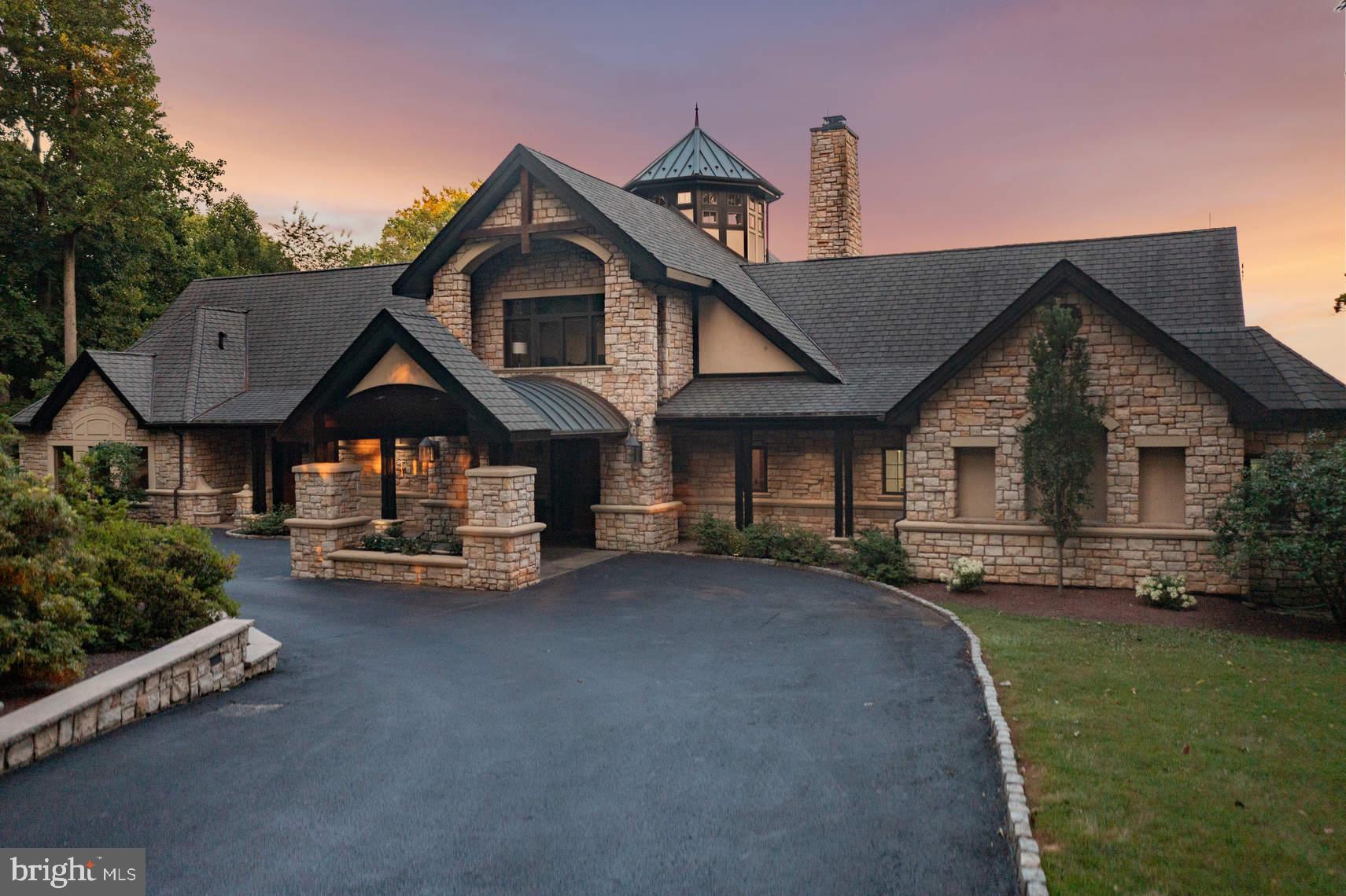 Breathtaking, panoramic views await the discerning buyer in this spectacular custom 4 Bedroom first-floor living home situated in a premier Fort Washington location. Start each day with a swim in the newly designed exercise room’s custom Endless Pool, complete with water jets and a submerged treadmill. Completely rebuilt in 2003 to have cathedral ceilings, gorgeous cherry wood floors, hand-crafted millwork, and stunning amenities, the house is situated far back from the road on a 2.9-acre lot in a premier Fort Washington location. The circular drive with custom lanterns set in a stone retaining wall ends at a porte-cochere and the covered front porch. Enter to view a 25’ wall of windows, providing a front-to-back view of the spectacular grounds, and a soaring 40’ wood ceiling with exposed beams. A cupola with plenty of windows brings in light to the beautiful Great Room and stunning dining area with a cherry wood coffered ceiling. Steps away is the outstanding Gourmet Kitchen & Breakfast Room with vaulted ceilings that has granite counters, a stainless Thermador range, double ovens, an extra wide & deep double stainless sink, 42" cabinets, and a Subzero refrigerator with reverse osmosis water. The Study is another architectural gem with a coffered ceiling & custom built-ins. The resort-like Primary Bedroom, also with a vaulted ceiling, features a professionally organized walk-in closet, a magnificent ensuite bathroom with radiant heated floor, marble counters, and a round whirlpool tub & spa shower with multiple shower heads. A glass sliding door accesses the rear flagstone patio that spans the length of the fenced rear yard and provides access to a fish fountain, expansive pool, and a pool room with a full bath. 3 additional spacious bedrooms, 2 full baths, and a Laundry Room complete the main floor. A 2nd-floor loft with a vaulted ceiling overlooks the Great Room & provides access to a balcony overlooking the front grounds. Words can't adequately describe the beauty of the rear grounds. This property is a virtual nature preserve with views of deer in the winter, bald eagles in the summer, and the beauty of the surrounding valley & 15th hole of Manufacturers' Golf Course in the distance. Other features include a top-tier home network system that gives great wifi coverage and is compatible with both 2.4 and 5G networks. Additionally, a customizable house-wide Savant system with easy to use app controls 3 zones of HVAC, security, and a whole house sound system. Visit this unique property!