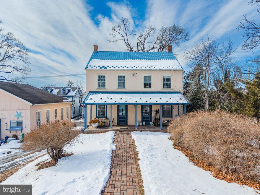 Own a piece of Bucks County history with this beautifully preserved 1870 farmhouse, ideally located within the Palisades School District. Rich in character and timeless charm, the home features wide-plank hardwood floors throughout, instantly transporting you to another era. The first floor showcases classic farmhouse details, including a country kitchen with exposed beams and an original brick fireplace once used for cooking. A spacious dining room offers another original fireplace, thoughtfully concealed behind custom doors, while the large living room and additional sitting room provide comfortable gathering spaces. The sitting room opens to an enclosed porch, perfect for morning coffee or relaxing evenings. A recently added first-floor powder room adds modern convenience. Upstairs, you’ll find four generously sized bedrooms, all with hardwood floors, along with a full bathroom. A walk-up attic provides ample storage or potential for future expansion. The property sits on approximately half an acre and includes a newly built two-car garage/pole barn with a metal roof, offering excellent storage, workspace, or hobby potential. Major updates include a brand-new metal roof and a mini-split system, blending modern efficiency with historic appeal. This rare offering delivers space, charm, and peace of mind—an exceptional opportunity to own a true piece of Quakertown history.
