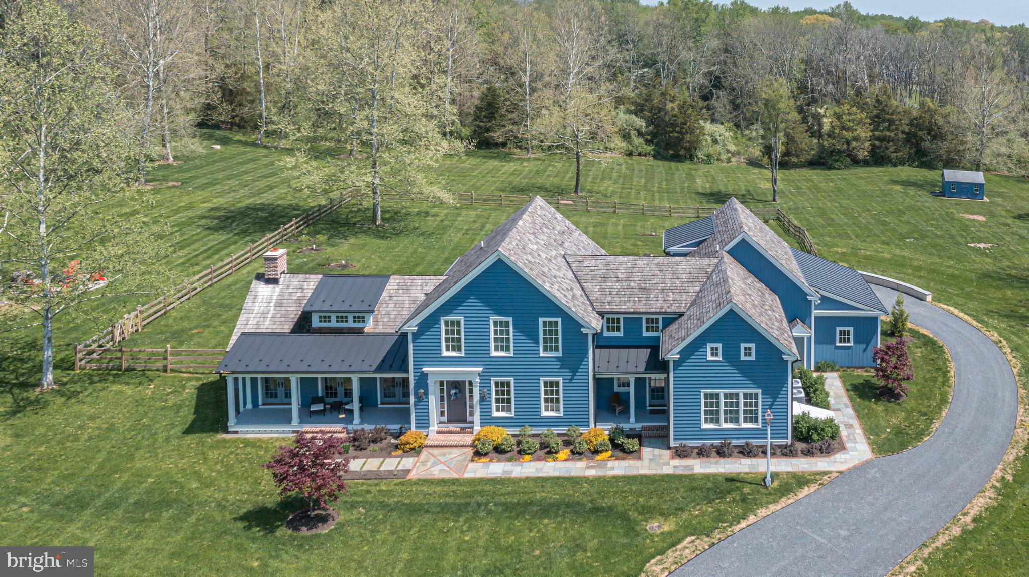 Eye-catching architecture united with a vibrant yet soothing hue makes this newer construction home a pleasant and unique opportunity. Brilliantly planned 4100 sqft on just over 4 acres in Solebury. Random width pine floors throughout, welcoming covered front porch, relaxing sunroom overlooking the backyard and so many refreshing details in between. Elegant brick and bluestone paths lead the way into this amazing home. Enjoy a formal dining room with convenient butler’s area allowing for easy entertaining with sink and beverage refrigeration. A truly inspiring Great Room with a vaulted, decorative beam ceiling, front to back outdoor spaces and highlighting a wood-burning fireplace and custom bookshelves will quickly become an enjoyable space for all. This fantastic room is open to the Gourmet Kitchen showcasing a sizable butcher block island, contrasting custom cabinetry, Quartz counters, induction cook-top and lovely breakfast area infused with wonderful natural light. Tucked away on the opposite wing of the home is the serene Primary Suite with a spacious bath featuring a huge walk-in shower and custom vanity with dual sinks. The upper level hosts 2 En-Suite Bedrooms, loft area perfect for working from home, enormous Bonus Room to satisfy any needs and an ideal storage room. The unfinished lower level allows for additional storage and versatility with a Bilco door out to the yard. This custom built and designed 3 year old home offers the benefits of newer systems and more modern architecture while enjoying wonderful character throughout. Tremendous value on a beautiful lot with a wooded buffer in back and preserved land across the street and within the highly desired New Hope – Solebury school district.