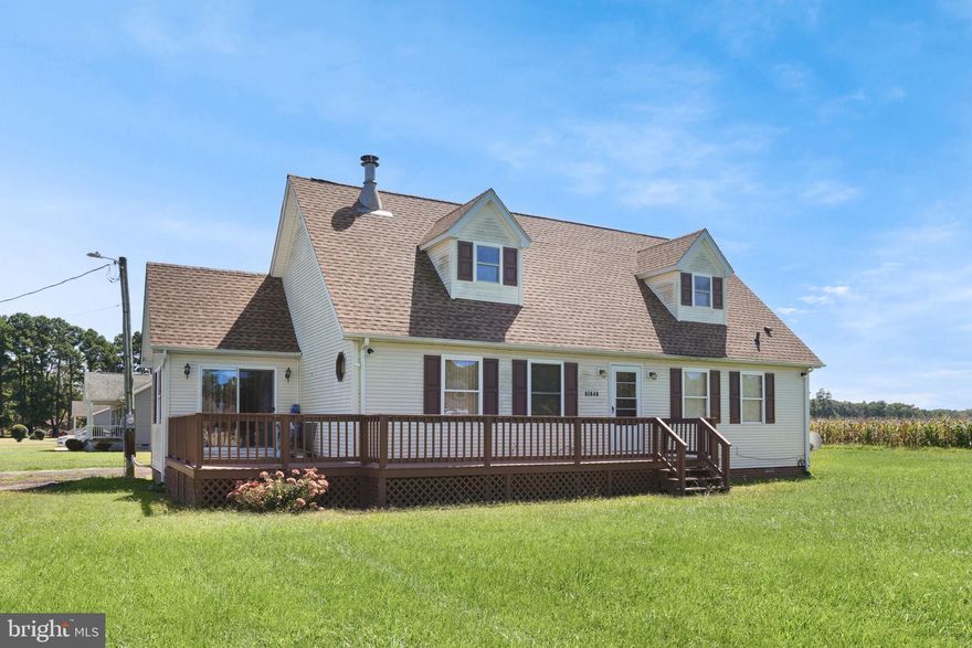 This charming Cape Cod-style home is situated on .77 acre and boasts 2 spacious bedrooms & 2 full baths. The inviting living room welcomes you, perfect for relaxation or entertaining guests. The dining room is ideal for family meals and special occasions. The kitchen, adorned with oak cabinetry, offers ample storage and functionality for all your culinary adventures. The den, featuring a stunning cathedral ceiling, provides an additional cozy retreat. The primary suite includes a private bath, ensuring a serene space for rest and rejuvenation. A second full bath accommodates family and guests with ease. There is a laundry/mud room, adding a practical touch to daily living. Upstairs is an unfinished attic which would be a great space for a guest suite or recreational area. Outdoor living is a delight with a huge deck ideal for gatherings and relaxation. The property also features a carport for added convenience. Notably, the roof has been replaced within the past 3 years, ensuring peace of mind. This home skillfully blends classic charm with modern amenities, presenting a unique opportunity for spacious, comfortable living. Seller offering $3,000 credit towards purchaser's closing costs!