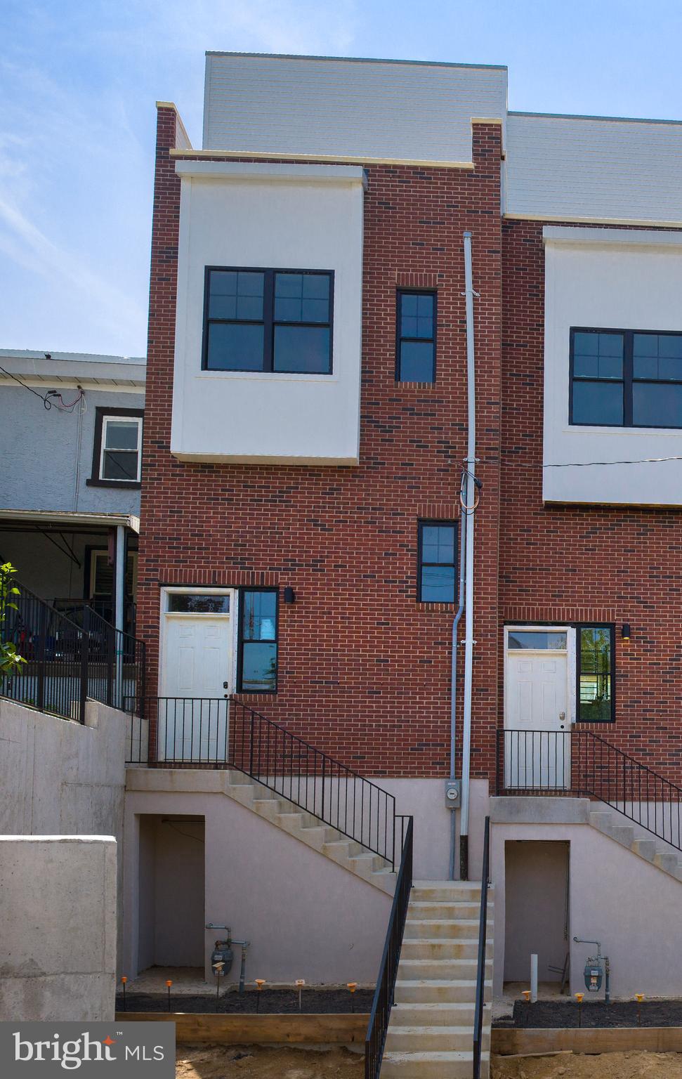 Nearing completion, this stunning home is one of just three exclusive residences located at the border of Roxborough and Manayunk—offering a rare blend of modern luxury, outdoor living, and walkable city convenience. This 3-bedroom, 2.5-bath, 3,000 sq ft residence stands out with a spacious full backyard and a front-to-back roof deck, creating exceptional spaces to relax, entertain, and take in sweeping views.
The main level features an open-concept kitchen, living, and dining area filled with natural light and designer finishes. The beautifully appointed kitchen opens directly to the private backyard—ideal for outdoor dining, gardening, or simply enjoying the fresh air.
The second floor includes two generous bedrooms, a stylish hall bath, and a convenient laundry area. The entire third floor is devoted to the luxurious primary suite, complete with multiple closets, a spa-like bath with soaking tub and walk-in shower, and a truly special feature: a private front porch just off the bedroom. This serene outdoor space is perfect for morning coffee, evening unwinding, or simply soaking in the neighborhood views.
Also on the third level, a wet bar adds a touch of ease and sophistication as you step out to the expansive roof deck that runs from front to back of the home—an impressive space for entertaining or taking in the skyline.
The finished lower level with high ceilings adds even more flexibility—perfect for a media room, gym, game space, or golf simulator.
Just steps from Manayunk’s vibrant Main Street, restaurants, shops, trails, and transit, this home blends style, space, and location in a way that’s hard to find. Thoughtfully designed with indoor-outdoor living in mind, it’s a unique opportunity you won’t want to miss.