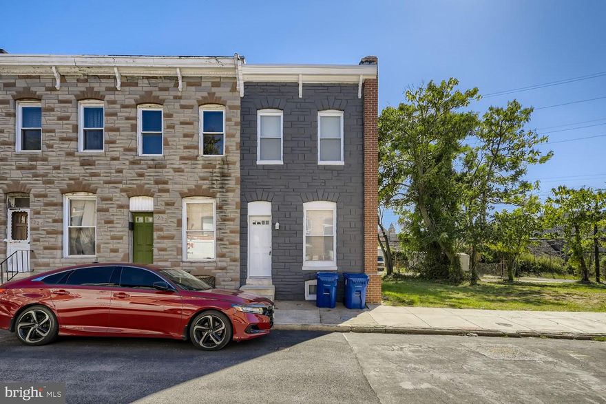 Newly renovated 2BR/2BA end of row townhome located in a revitalizing neighborhood near Johns Hopkins!  Step up to the freshly painted brick facade and open the door into your forever home.  Inside is a bright and airy open concept main floor with luxury flooring covering both the main and second floor.  The spacious living room offers views into the dining area and kitchen.  The beautifully renovated kitchen offers stainless steel appliances, plenty of cabinets with double pantries surrounding the fridge, a stainless under mount sink set into a stunning granite countertop with a brillant backsplash.  Above the stairs to the second floor is a skylight that brings in tons of light to both floors., There are two spacious bedrooms, one with access to a newly constructed balcony, and a 4 piece spa-like full bath featuring a large soaker tub with a tiled accent wall with an inlay design that carries into the extra large shower with a built-in bench and skylight above. The lower level is finished with ceramic tile flooring, a large family room, a new full bath with a walk-in shower featuring a glass block window, laundry, storage, and access to the rear.  From the kitchen step out onto a covered newly constructed deck overlooking a large patio/1-car parking pad.  This home is move-in ready with so much to offer new homeowners including freshly painted inside and out, updated plumbing, new HVAC and water heater, and a new rubber roof.  Imagine all this and in close proximity to the Inner Harbor, Patterson Park, Johns Hopkins Hospital, and Henderson Hopkins School!