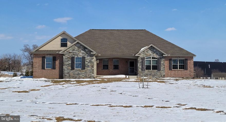 Like-New Rancher on 3 Acres with Mountain & Pastoral Views - Welcome to this stunning, nearly new rancher, just 4 years old and meticulously maintained, this home truly feels like new.   Features 3 bedrooms, 2 full baths & 2 half baths.  The open floor plan features 9' ceilings and a bright great room with beautiful wood floors and a cozy gas fireplace—perfect for everyday living or entertaining. The eat-in kitchen is a dream, offering granite countertops, a large center island, and all appliances included. Two dining areas provide flexibility for casual meals or formal gatherings.
The private primary bedroom suite is a peaceful retreat with a walk-in closet and a stylish en-suite bath featuring a walk-in shower, double vanity, and tile flooring. The second and third bedrooms are thoughtfully located on the opposite side of the home, offering privacy for family or guests.
French doors open to a dedicated home office with serene pastoral views—ideal for remote work or a quiet study.  Main-level laundry includes washer and dryer for added convenience.
Additional highlights include triple garage with workshop space, a walk-up attic heated & cooled and offers abundant storage or potential to convert into additional living space.  The finished basement has a spacious family room, second fireplace, half bath, and storage galore.  Even the crawl space is insulated and temperature-controlled—no detail overlooked.    Nice level lot, large back porch with view of 300+ trees planted for privacy in rear.  Peaceful country living with modern comforts, stunning views, and room to grow—this exceptional rancher checks every box.   Located 10 min from Greencastle, 7 min to Mercersburg.