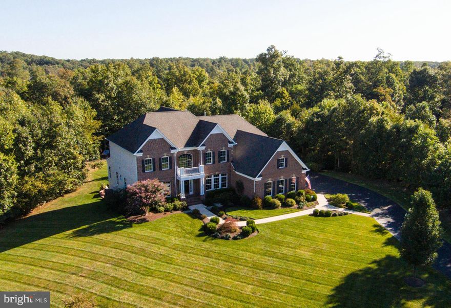Better than new!  Nearly 7000 on 3 acres near Fairfax/Loudoun Border!  Wider plank hardwoods on main, open and light filled floorplan w/ gourmet kit, sunroom that opens to deck, patio and private oasis of back yard. Lrg FR w/ FP, library, formal LR/DR. Master suite w/ FP, sitting, spa bath & walk-in, ALL BRs have full bath! LL walkout w/ wet bar, 2 French doors open to patio, den, storage