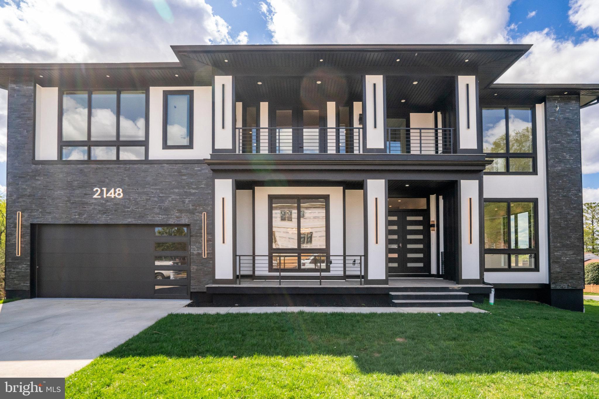 Nestled in the heart of Falls Church. With over 7,289 square feet of living space, this residence is a testament to meticulous design and thoughtful attention to detail.
The architectural plan reveals a harmonious blend of comfort and privacy, with seven generously proportioned bedrooms, each with its own en-suite bathroom and custom closet. The main level is an ode to modern living with ceiling height of 11ft and an open floor plan that is both contemporary and welcoming. The white oak floors provide a canvas for customization, allowing you to select the finish that best suits your aesthetic.
Entertaining is effortless with a formal dining room that transitions smoothly into a state-of-the-art gourmet kitchen through a well-equipped butler’s pantry. The kitchen is a chef's dream, featuring top-of-the-line Thermador appliances and a kitchen island with bar-style seating. This culinary haven opens to a cozy breakfast area, perfect for informal family gatherings.
The family room, anchored by a warm gas fireplace and offering direct patio access, is the home's heart, designed for relaxation and social gatherings. A guest bedroom on the main level ensures comfort and convenience for visitors, complete with an en-suite bathroom and walk-in closet.
The upper level , the primary suite stands out as a sanctuary of luxury, with dual walk-in closets and an opulent en-suite bathroom complete with a shower and soaking tub. Each of thebedrooms is a private retreat, featuring walk-in closets and individual en-suite bathrooms. The family loft adds another layer of versatility to the home, providing a space for relaxation or play, along with convenient balcony access.
The full basement extends the living space further, offering a recreation room with a wet bar, two bedrooms with en-suite bathrooms, and a media room dedicated to entertainment. A separate gym room caters to the wellness enthusiast, while ample storage space ensures practicality. The mudroom leads to a spacious 2-car garage, completing the layout of this exceptional home.
This residence is not just a house; it is a promise of a lifestyle that embodies sophistication, luxury, and unparalleled comfort. It awaits the discerning individual who values quality, elegance, and the opportunity to create a home that is truly their own.