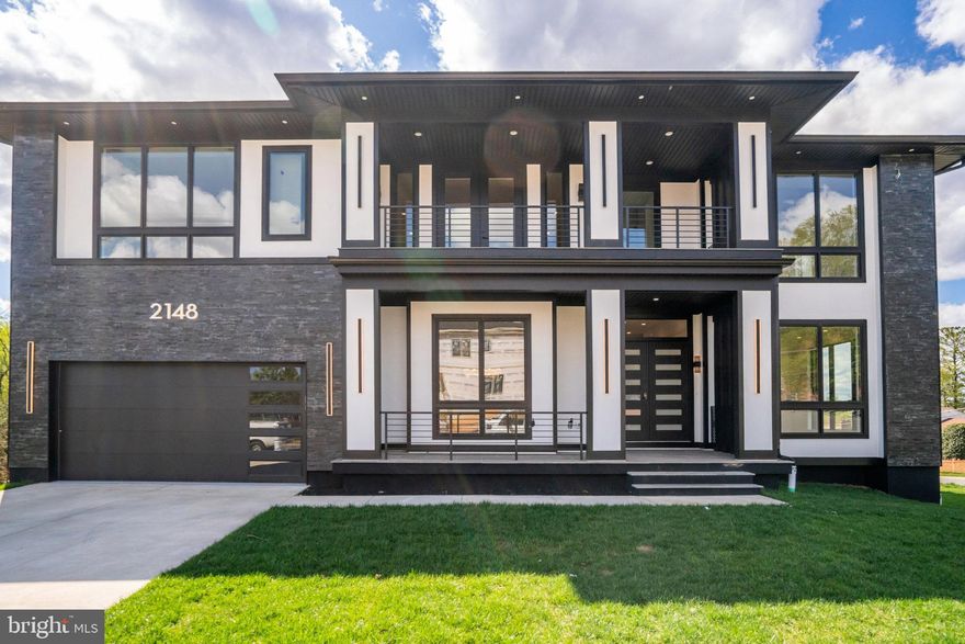 Nestled in the heart of Falls Church. With over 7,289 square feet of living space, this residence is a testament to meticulous design and thoughtful attention to detail. 
The architectural plan reveals a harmonious blend of comfort and privacy, with seven generously proportioned bedrooms, each with its own en-suite bathroom and custom closet. The main level is an ode to modern living with ceiling height of 11ft and an open floor plan that is both contemporary and welcoming. The white oak floors provide a canvas for customization, allowing you to select the finish that best suits your aesthetic. 
Entertaining is effortless with a formal dining room that transitions smoothly into a state-of-the-art gourmet kitchen through a well-equipped butler’s pantry. The kitchen is a chef's dream, featuring top-of-the-line Thermador appliances and a kitchen island with bar-style seating. This culinary haven opens to a cozy breakfast area, perfect for informal family gatherings. 
The family room, anchored by a warm gas fireplace and offering direct patio access, is the home's heart, designed for relaxation and social gatherings. A guest bedroom on the main level ensures comfort and convenience for visitors, complete with an en-suite bathroom and walk-in closet. 
The upper level , the primary suite stands out as a sanctuary of luxury, with dual walk-in closets and an opulent en-suite bathroom complete with a shower and soaking tub. Each of thebedrooms is a private retreat, featuring walk-in closets and individual en-suite bathrooms. The family loft adds another layer of versatility to the home, providing a space for relaxation or play, along with convenient balcony access. 
The full basement extends the living space further, offering a recreation room with a wet bar, two bedrooms with en-suite bathrooms, and a media room dedicated to entertainment. A separate gym room caters to the wellness enthusiast, while ample storage space ensures practicality. The mudroom leads to a spacious 2-car garage, completing the layout of this exceptional home. 
This residence is not just a house; it is a promise of a lifestyle that embodies sophistication, luxury, and unparalleled comfort. It awaits the discerning individual who values quality, elegance, and the opportunity to create a home that is truly their own.