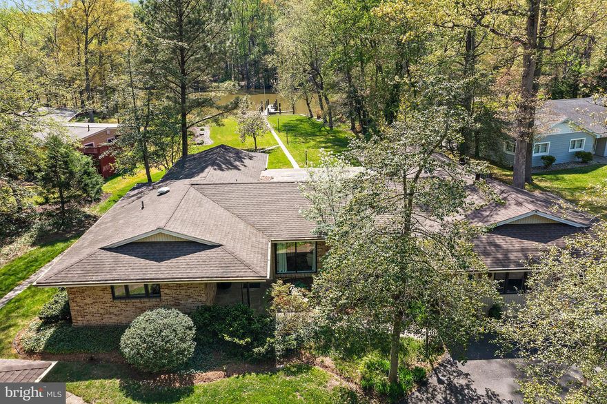 Mid-Century Modern Waterfront Retreat on Over Half an Acre! This stunning 3,400+ sq ft rancher blends timeless mid-century architecture with modern luxury—all on one expansive level. Set on a rare, flat lot along the tranquil waters of Cub Neck Creek, just off the the Rhode River. This home is a true power boater’s paradise with private dock and multiple slips. Soaring vaulted ceilings and walls of glass flood the open-concept living spaces with natural light and showcase peaceful waterfront views. The updated gourmet kitchen features a large island and a flexible space perfect for a home office or breakfast nook. Step outside to the slate patio for seamless indoor-outdoor living—ideal for entertaining or relaxing by the water. Hardwood floors, granite countertops, and sophisticated design details make this home truly exceptional. Easy access to Annapolis , DC and Baltimore!