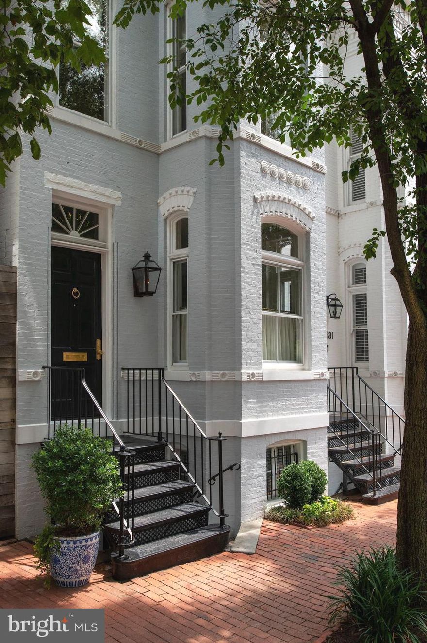 Welcome to this exquisite residence, carefully renovated to blend timeless elegance with modern luxury. Nestled in the heart of Georgetown’s sought-after East Village, this home showcases soaring ceilings, rich architectural details, and impeccable high-end finishes throughout. The expansive living spaces feature an elegant living room with a beautiful fireplace mantle, large windows and a stunning staircase as it opens into the spacious dining room. The chef’s kitchen in the rear of the home is light and bright and incredibly functional. The kitchen features top-of-the-line appliances, custom Neolith countertops, and an indoor/ outdoor feel as it walks out to the private rear deck —perfect for both everyday living and entertaining. Upstairs, the primary bedroom is a serene retreat with thoughtful built-ins, a walk in closet and ensuite bathroom with marble finishes and Waterworks fixtures. There are two additional bedrooms and a renovated hall full bath also with marble surfaces and Waterworks fixtures. The lower level has a great family room, renovated full bathroom, and additional space for a gym, bedroom, or storage etc. The lower level has a large laundry room, multiple storage areas, access to additional outdoor space, and a separate front entrance. Every detail has been thoughtfully curated to preserve this  home’s historic character while delivering a gorgeous interior for easy modern living. All this just steps from Georgetown’s great restaurants, shops, and many neighborhood parks. Approx 2,300 sq ft total per floor plans.