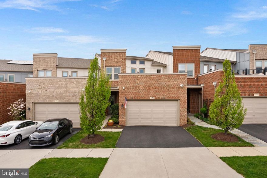 Welcome to the highly sought-after 55+ community of Birchwood at Brambleton, where lifestyle and comfort come together seamlessly. This barely lived-in townhome offers 4 bedrooms and 3.5 baths, thoughtfully designed to accommodate a variety of living arrangements with dual primary suites on both the main and upper levels. 

A neutral palette throughout creates the perfect blank canvas, ready for your personal touch, while custom built-in bookshelves add both character and functional design. The main level features gleaming hardwood floors and a beautifully appointed kitchen with granite countertops, stainless steel appliances, and effortless flow into the living and dining spaces—ideal for everyday living and entertaining.

Outdoor living is exceptional and truly sets this home apart. Enjoy a custom deck with a built-in drainage system, a patio just off the kitchen for easy indoor-outdoor gatherings, and a rooftop terrace showcasing peaceful water views—perfect for relaxing or entertaining guests.

Privately positioned with a rare, treed buffer and no homes directly behind, this home offers a level of privacy not often found in townhome living.

Birchwood at Brambleton is known for its resort-style amenities centered around a stunning 20,000 sq. ft. clubhouse featuring indoor and outdoor pools, a fitness and wellness center, yoga studio, golf simulator, art studio, theater and game rooms, and indoor/outdoor social spaces. Residents also enjoy pickleball and bocce courts, scenic walking and biking trails, community gardens, a fishing pier, and a full calendar of social events and activities designed for an active adult lifestyle.

This is a rare opportunity to enjoy low-maintenance living in one of Loudoun County’s premier active adult communities.