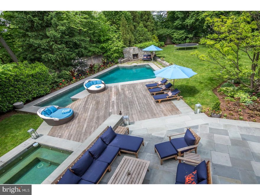 This landmark Queen Anne Victorian stone residence was built in 1885 by Henry Houston and designed by G.W. & W.D. Hewitt with an addition commissioned by Mr Houston in 1911 and designed by prominent architects of the period Duhring,Okie & Ziegler.  Fine details of the era include high ceilings, wood floors, exquisite millwork, crown moldings, built-ins and throughout you will find nine intricate wood carved mantels with either tile or brick surrounds.  Situated in one of Chestnut Hill's most premier locations, this distinctive property offers a circular driveway and a beautifully refurbished two-story open front porch,  From the spacious entrance hall with powder room and coat closet, you enter into the spectacular light-filled great room that offers two seating areas, built-ins,a wood burning fireplace, large windows plus French doors that offer access to the magnificent grounds.  There is a formal dining room, butler's pantry and a spacious updated gourmet kitchen with quartz counter top,stainless steel appliances, center island with granite counter, cook top stove plus counter seating, double ovens and lots of additional space for a large table.  The adjacent mud room offers built-in custom cabinets, laundry room, powder room and two exits to the outside.  On the upper floors you will find the master bedroom suite with remodeled master bathroom and sitting room/dressing room.  There are five more generous sized bedrooms, two additional new hall bathrooms, an upstairs family room with access to the porch, a second laundry room and a spacious study/play room.  The outside space is amazing!  The grounds include a flagstone terrace, wood decking, Armond Aquatech Pool, hot tub, stone wall with wood burning fireplace and beautifully landscaped grounds.  Updates & improvements galore include new HVAC (2015), upgraded 400 amp electric, newer septic system, two new hall bathrooms (2016), updated kitchen (2017), freshly painted interior (2017) and many technology updates including IC Realtime 8 Channel DVR w/8 cameras and a Ruckus Zone Director & 5 Wireless Access Points including outdoors.  (A complete list of Improvements is part of the Seller's Disclosure.  See FloorPlanOnline for room measurements) This beauty is truly a perfect blend of a bygone era with the most modern amenities.  Superior Top-of-the-Hill location! Just a short walk to the quaint shops, many restaurants, the local train lines and the hiking trails of the Wissahickon.