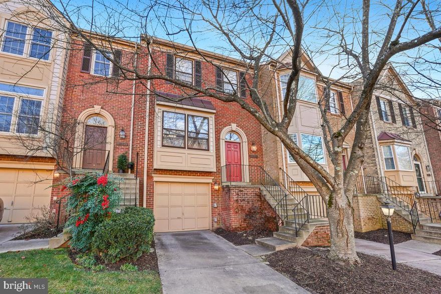 DUE TO INCLEMENT WEATHER, SATURDAY'S OPEN HOUSE IS CANCELLED.Pride of ownership abounds in this brick-front garage townhouse in sought-after Potomac Grove. Flooded with natural light from numerous skylights, this luxury, move-in ready, property—backing to common space and a tot lot—showcases an open floor plan and numerous decorator touches including hardwood flooring on both the main and upper levels. The formal living room with a box bay window, the gracious dining room and the convenient powder room greet you upon entry. The renovated, gourmet, island kitchen features 42-inch cherry cabinets—some with 2-sided glass fronts—stainless steel appliances, granite counters and 2 pantries. The adjoining skylit family room exits to the deck overlooking trees. Upstairs finds a dramatic primary suite with a walk-in closet and a remodeled bath, 2 additional bedrooms and the hall bath. All bedrooms feature vaulted ceilings. The finished walkout lower level boasts a recreation room with its fireplace, wet bar and luxury vinyl flooring, half bath, laundry room and garage access. Meticulously maintained and updated, a new roof, 3 new Velux skylights and larger capacity gutters were added in 2020 and the Trane  HVAC system was replaced in 2018.