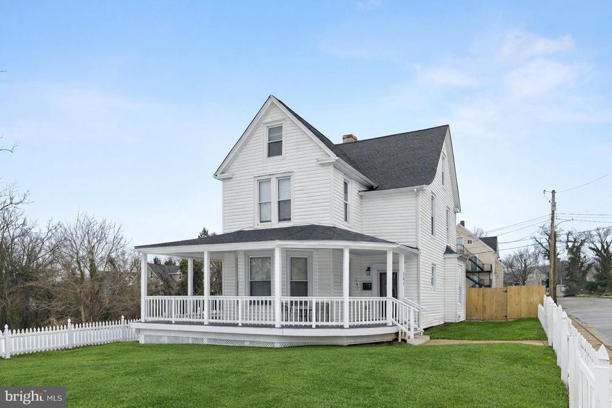 Stunningly renovated and positioned on a corner lot, this exceptional home offers an abundance of space, style, and versatility. A fully fenced yard and inviting wraparound front porch welcome you into an open foyer highlighted by luxury vinyl plank flooring and soaring ceilings, seamlessly guiding you into the formal living room. Designed for both entertaining and everyday comfort, the living room features a coffered ceiling, abundant natural light, and the continued warmth of the luxury flooring.  At the heart of the home, the beautifully appointed kitchen showcases Corian countertops, a classic subway tile backsplash, 42” cabinetry with soft-close drawers, stainless steel appliances, and a center island with breakfast bar, all enhanced by an intricate tray ceiling. The kitchen opens effortlessly to the dining area, where a coffered ceiling and wood-burning fireplace with brick surround create a timeless and inviting ambiance. French doors lead to a spacious sunroom with vaulted ceilings, a convenient laundry, and direct access to the fenced backyard, perfect for indoor-outdoor living.  The upper level hosts a serene primary suite offering a spa-like retreat with high ceilings, a walk-in closet, and a ceramic tile en-suite bath featuring a walk-in shower. Two additional bedrooms and a full hall bath complete this level. The penthouse level expands the home’s flexibility with a bedroom, full bath, and an additional space ideal for a home office, playroom, or guest suite. The lower level provides exceptional storage.  Ideally located with easy access to major commuter routes, including I-695, I-95, and I-83, this home offers convenient travel to downtown Baltimore, Hampden, Washington, D.C., and points north, blending refined living with unmatched accessibility.  A new roof has been installed, and new photos will be uploaded.