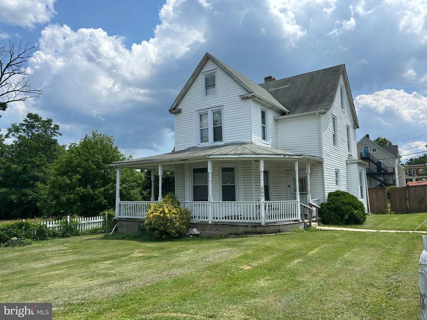 Stunningly renovated and positioned on a corner lot, this exceptional home offers an abundance of space, style, and versatility. A fully fenced yard and inviting wraparound front porch welcome you into an open foyer highlighted by luxury vinyl plank flooring and soaring ceilings, seamlessly guiding you into the formal living room. Designed for both entertaining and everyday comfort, the living room features a coffered ceiling, abundant natural light, and the continued warmth of the luxury flooring.  At the heart of the home, the beautifully appointed kitchen showcases Corian countertops, a classic subway tile backsplash, 42” cabinetry with soft-close drawers, stainless steel appliances, and a center island with breakfast bar, all enhanced by an intricate tray ceiling. The kitchen opens effortlessly to the dining area, where a coffered ceiling and wood-burning fireplace with brick surround create a timeless and inviting ambiance. French doors lead to a spacious sunroom with vaulted ceilings, a convenient laundry, and direct access to the fenced backyard, perfect for indoor-outdoor living.  The upper level hosts a serene primary suite offering a spa-like retreat with high ceilings, a walk-in closet, and a ceramic tile en-suite bath featuring a walk-in shower. Two additional bedrooms and a full hall bath complete this level. The penthouse level expands the home’s flexibility with a bedroom, full bath, and an additional space ideal for a home office, playroom, or guest suite. The lower level provides exceptional storage.  Ideally located with easy access to major commuter routes, including I-695, I-95, and I-83, this home offers convenient travel to downtown Baltimore, Hampden, Washington, D.C., and points north, blending refined living with unmatched accessibility.  A new roof has been installed, and new photos will be uploaded.