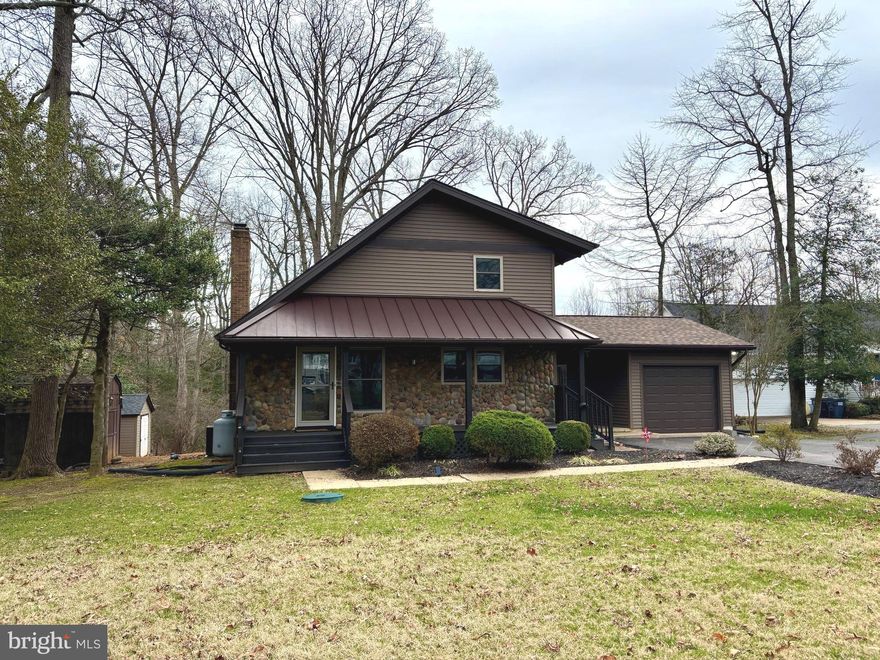 Welcome to this beautifully maintained contemporary home in the sought-after Society Hill section of Breton Bay, offering privacy, space, and timeless character on a generous .60-acre lot. From the moment you step inside, you’re greeted by soaring two-story ceilings in the great room, highlighted by rich hardwood floors and a striking stone gas fireplace that creates a warm and inviting focal point. The updated kitchen features granite countertops, distinctive wood ceilings, and seamless flow into the combined dining and living areas. A main-level bedroom and full bath provide flexible living options for guests or multigenerational needs.

Upstairs, you’ll find two additional bedrooms and a full bath, while the finished basement expands the living space with another bedroom and full bath, perfect for a private suite, home office, or recreation area. The screened-in porch overlooks the peaceful, private backyard, offering the perfect setting to relax and enjoy the natural surroundings. Major updates, including replacement windows, & siding within the last five to six years and a brand-new heat pump installed in 2026 and a new roof last year, provide added comfort and peace of mind. Located just minutes from downtown Leonardtown, waterfront amenities, and Breton Bay’s golf and marina lifestyle, this home offers the perfect blend of convenience, charm, and modern updates.