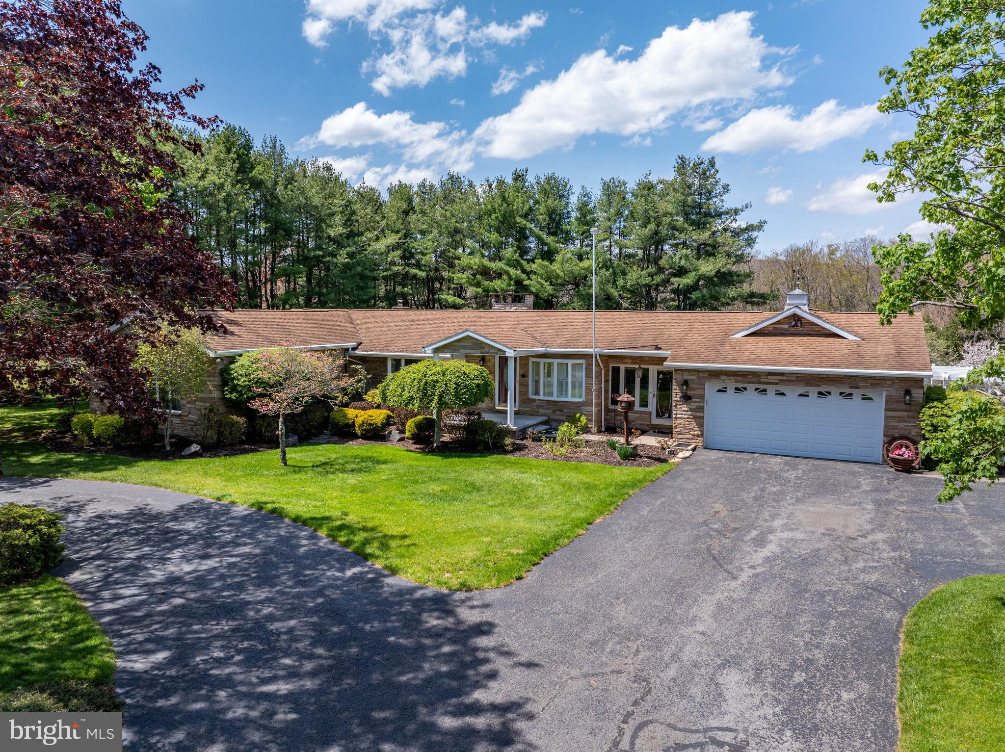Rare opportunity to own a beautiful home on 4 acres near DCL! This home is breathtaking from the moment you pull in. The care this property has been shown is very apparent, from the landscaping to the beautiful waterfall, which can be enjoyed from the brick patio. The interior of the home boasts hardwood floors, two stone fireplaces, a large kitchen and a stunning sunroom, not to mention a large game room downstairs. All this home needs are a few minor upgrades, to make it truly yours . The location is another plus, just minutes to DCL State Park, Thousand Acres Golf Club, restaurants, cinema, grocery stores and Wisp Resort. A property like this is a rare find, call today to preview!
