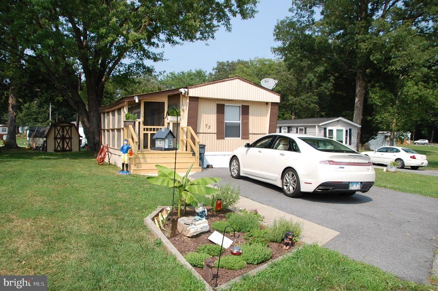 Welcome to a lovely spacious 2 Bedroom, 2 Bath with the bedrooms location at each end of the home for privacy.  A nice size Bright Living Room and good size Eat-in Kitchen with double sink. So much new - - -   Doors, Ceiling Fans, Up graded carpet and water resident padding, New Vinyl Flooring, blinds, 6 month 40 gallon water heater,  Heat Pump with oil back up, and More; Come See!!!  Outside nice 10X12 Shed and all new entrance to the Large Screened in Porch.

Ready for quick sale.  
Application for home purchase is required in this 55+ community.