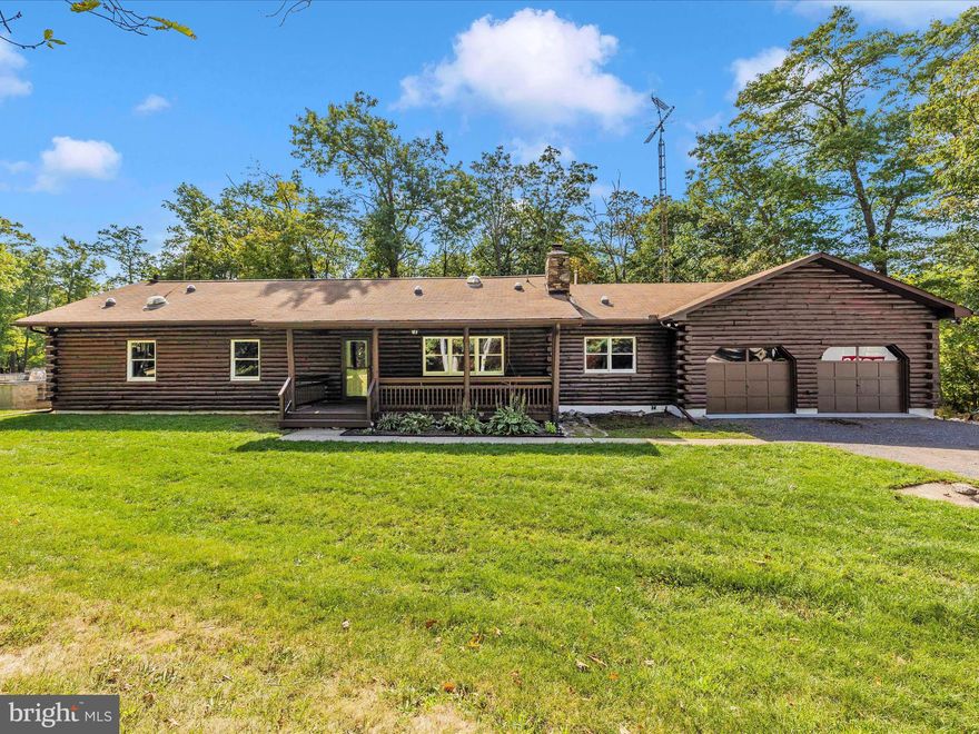 Nature lovers' paradise. Nestled in the trees on top of the mountain by Gambrill Park, this charming log home on 6.67 acres is ready for you to call it home.  Enjoy evenings snuggling by the beautiful stone fireplace or out front on the covered porch; this home offers a relaxed private lifestyle minutes to Frederick.   The wooded trails are perfect for nature walks or riding your dirt bikes for adventurous fun.  Inside, you'll enjoy the exposed log walls, updated fresh paint, large bedrooms, and renovated bathrooms.  The open floor plan offers a flexible living space to enjoy.  The oversized kitchen is perfect for entertaining. Full laundry rooms on each level.  The lower level was recently renovated and includes a separate kitchen, rec room, den, and full bath with a laundry area and outdoor entrance.  Perfect for guest quarters, multi-generational living, or even an Airbnb.   Plenty of room to expand.  Previous owners also added a concrete foundation for an addition and a detached garage. Excellent living inside and out.  Perfect 10!