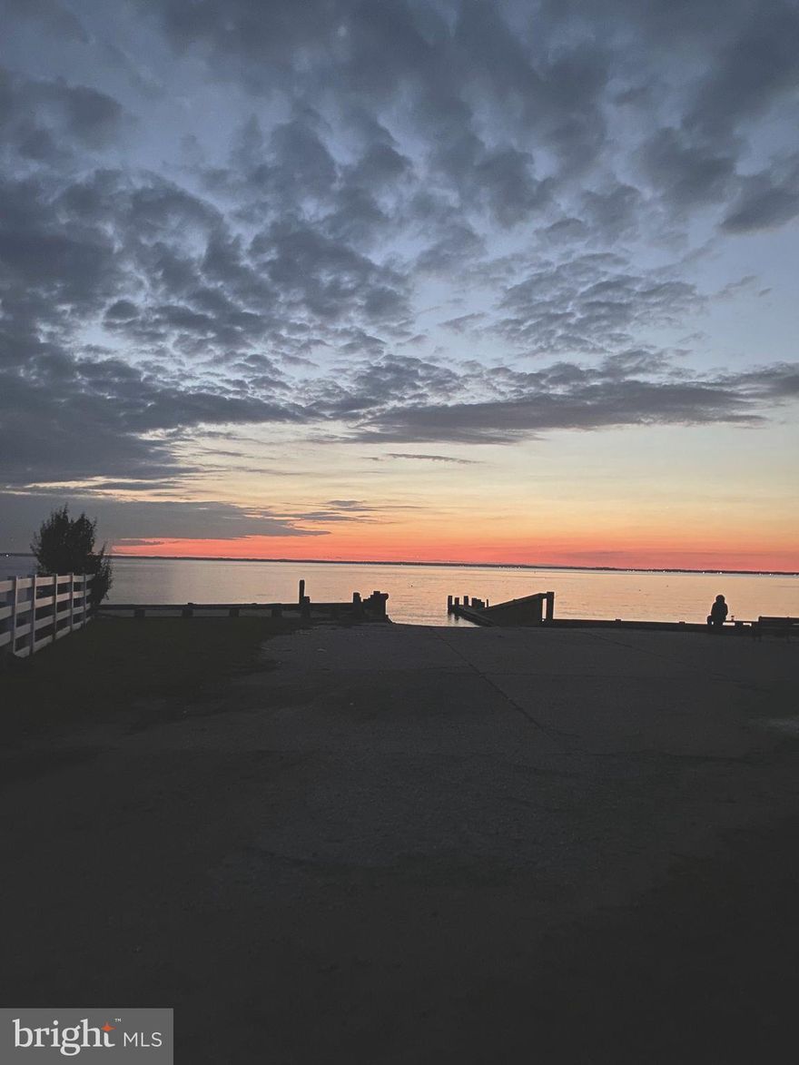 NOTE -  - Options available for a new pier / bulkhead and/or a 2-car garage....  Call to discuss in detail or STOP BY our weekend open houses....    Nantucket meets the Bay in this 5 bedroom, 3-4 bath Carriage Style Waterfront.  This Coastal Charmer has views from 3 sides and offers a Community Boat Ramp next door and Sandy Bayfront Beach directly across the street. Recent renovations include handsome hardwood floors, upgraded baths, new kitchen, new windows, new doors and new siding. Main level offers two bedrooms - ideal for extended family.  Second level offers 2 bedrooms with full bath and a huge water view Master Suite with a sprawling balcony.     The level 1.5 acres handles many types of additions