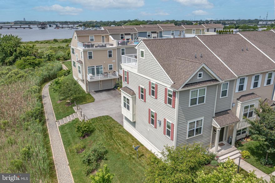 The Beauty of the Village of Bear Creek! This spectacular, immaculate, fully updated end-unit townhome overlooking Bear Creek and the Patapsco River is move-in ready! Perfectly positioned to offer exceptional coastal views from all rooms that will leave you breathless. A thoughtfully designed private level positions the primary bedroom with picturesque water views, private upgraded full bath, oversized full-length shower, and walk-in closet. Two additional spacious bedrooms and an additional full bath complete this level. Well-appointed with every convenience, you will be entertaining effortlessly on the 4th level Skydeck and loft: wet bar, wine fridge and storage, built-ins & wall mount for TV.  A double-sided gas fireplace and access to Skydeck with unrivalled water views makes this a space you won’t want to leave!  Main level living boasts hardwood flooring & a huge family room ready for any entertainment set-up. Modern kitchen with stainless steel appliances, new gleaming quartz countertops, upgraded cabinetry, kitchen island, sliding door to second balcony and panoramic views of the water. The lower level can be accessed by the oversized 2-car garage, and also features a 4th bedroom, storage and laundry. Access to private community deep water pier, boat slips, launch ramp for kayaks and paddle boards, the amenities are endless! Convenient to major commuting routes, shopping and dining!