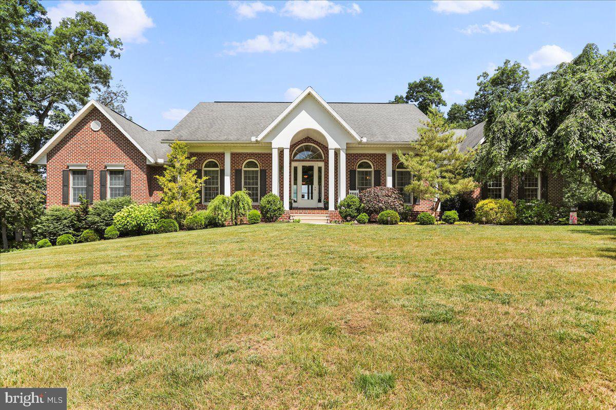 Luxurious custom-built home situated on over 2 acres on a quiet cul-de-sac. Beautiful, stunning views from your private deck overlooking Franklin County. This home offers four bedrooms, 3 full bathrooms and 2 half-baths. The living room features a gorgeous natural stone fireplace and custom cabinetry. Fully equipped kitchen features granite counter tops, stainless steel appliances with the dishwasher conveniently raised. Spacious formal dining room, breakfast nook and sunroom. The lower level is almost entirely finished including a large family room with a propane fireplace, a kitchenette and a bedroom with ensuite. There are two garages - an upper level three-car garage and an oversized lower level two-car garage. Outside is a two-level deck and patio with beautiful views of the Conococheague Creek and sightings of wildlife. A private haven but close to conveniences such as restaurants, groceries, shopping, Route 30, etc...