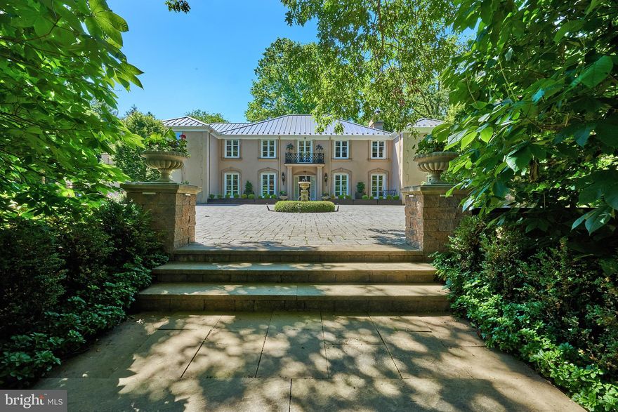710 Glengarry Road occupies an idyllic Chestnut Hill location, across from the Philadelphia Cricket Club's historic St. Martins golf course and steps from a footpath to the 2000-acre Wissahickon Valley Park. The distinctive French-inspired house and beautiful grounds were designed to accommodate both gracious entertaining and the day-to-day bustle of family life. Almost every principal room has multiple access points - to adjoining rooms and extensive stone terraces and gardens - that create an airy, spacious feeling and wonderful flow. Elements such as white-columned partitions, generous molding, graceful metalwork, classic light fixtures and wide doorways hung with richly stained solid-wood double doors combine to lend a clean, sophisticated elegance to the more formal parts of the house. Other, less obvious items, such as 5-zoned AC and 9-zoned heating (including radiant underfloor heating throughout the Great Room), are nods to comfort and efficiency. Family and guests will also enjoy the special privacy and convenience of a professionally designed home cinema and a dedicated exercise room, complete with flat-screen TV and adjoining full bath. (The latter space, built to be versatile, could function as an in-law or maid's suite, etc.) On the second floor, the Master Suite occupies its own separate wing; each of the three additional bedrooms has a full bath and dressing room or walk-in closet. Surrounding the house are grounds that feature majestic trees, mature shrubbery, large patio areas, built-in barbecue station, in-ground pool, pergola, and several flower gardens. This is a lovely, carefully designed and immaculately maintained residence in a tranquil park-like setting, yet only blocks from 2 regional rail stations and less than a mile from the shops and restaurants of Germantown Avenue.