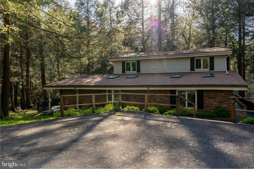 Nestled on 1.52 private acres with 500 feet of frontage on Deep Creek Lake, this 5-bedroom, 4.5-bath home combines comfort with exceptional waterfront living. The open floor plan features soaring two-story ceilings with exposed beams, wood flooring, upgraded countertops, and a striking brick fireplace. Outdoor spaces include multiple decks, balconies, porches, and a hot tub—perfect for entertaining or relaxing while taking in serene lake and wooded views. With private access and riparian rights, enjoy year-round activities, from kayaking and swimming in the summer to peaceful lakefront living in every season. Conveniently located just minutes from Wisp Resort, shopping, dining, and local attractions, this property truly offers the best of Deep Creek Lake living.